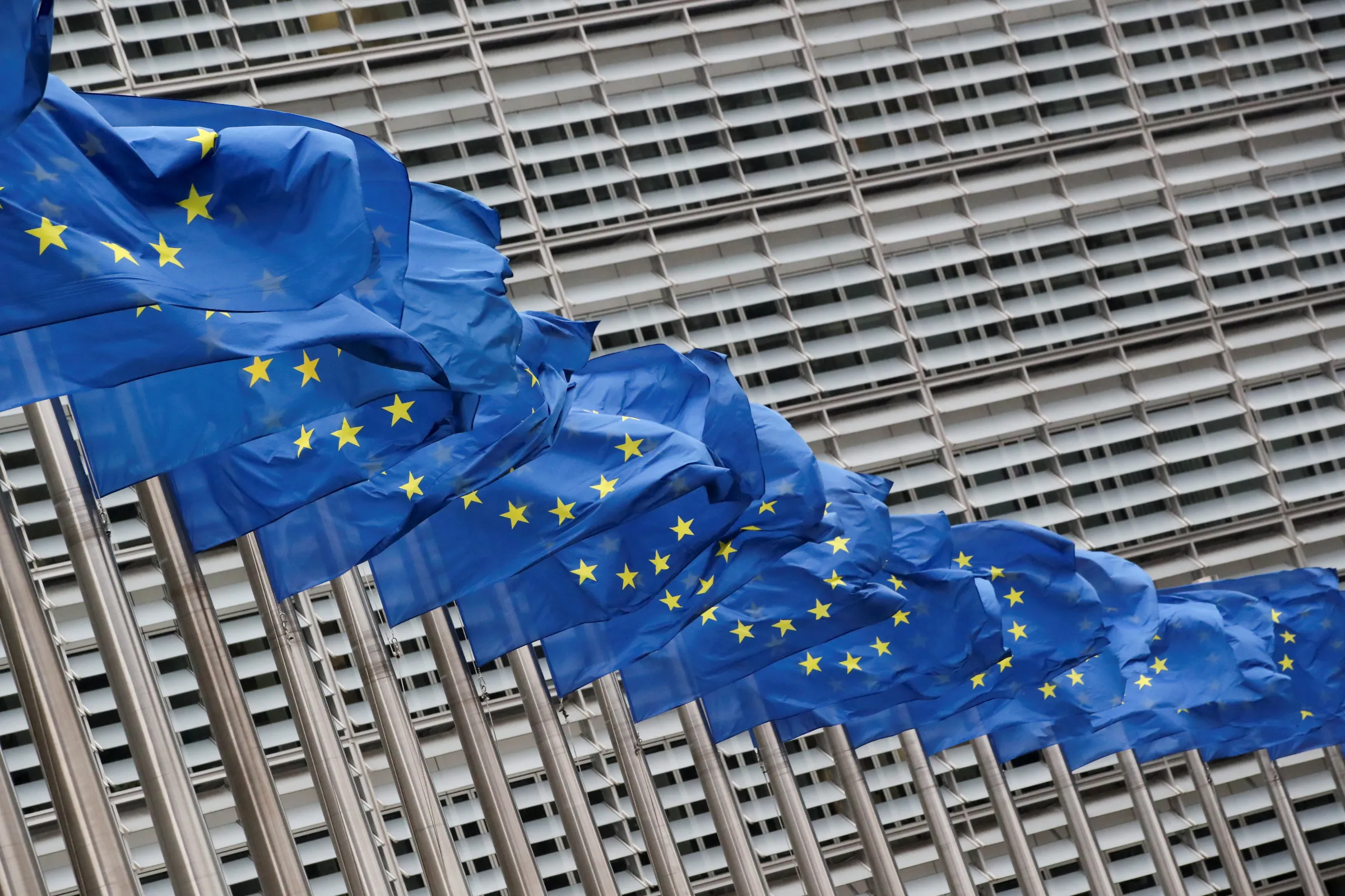 European Union flags flutter outside the EU Commission headquarters in Brussels, Belgium, July 14, 2021. REUTERS/Yves Herman