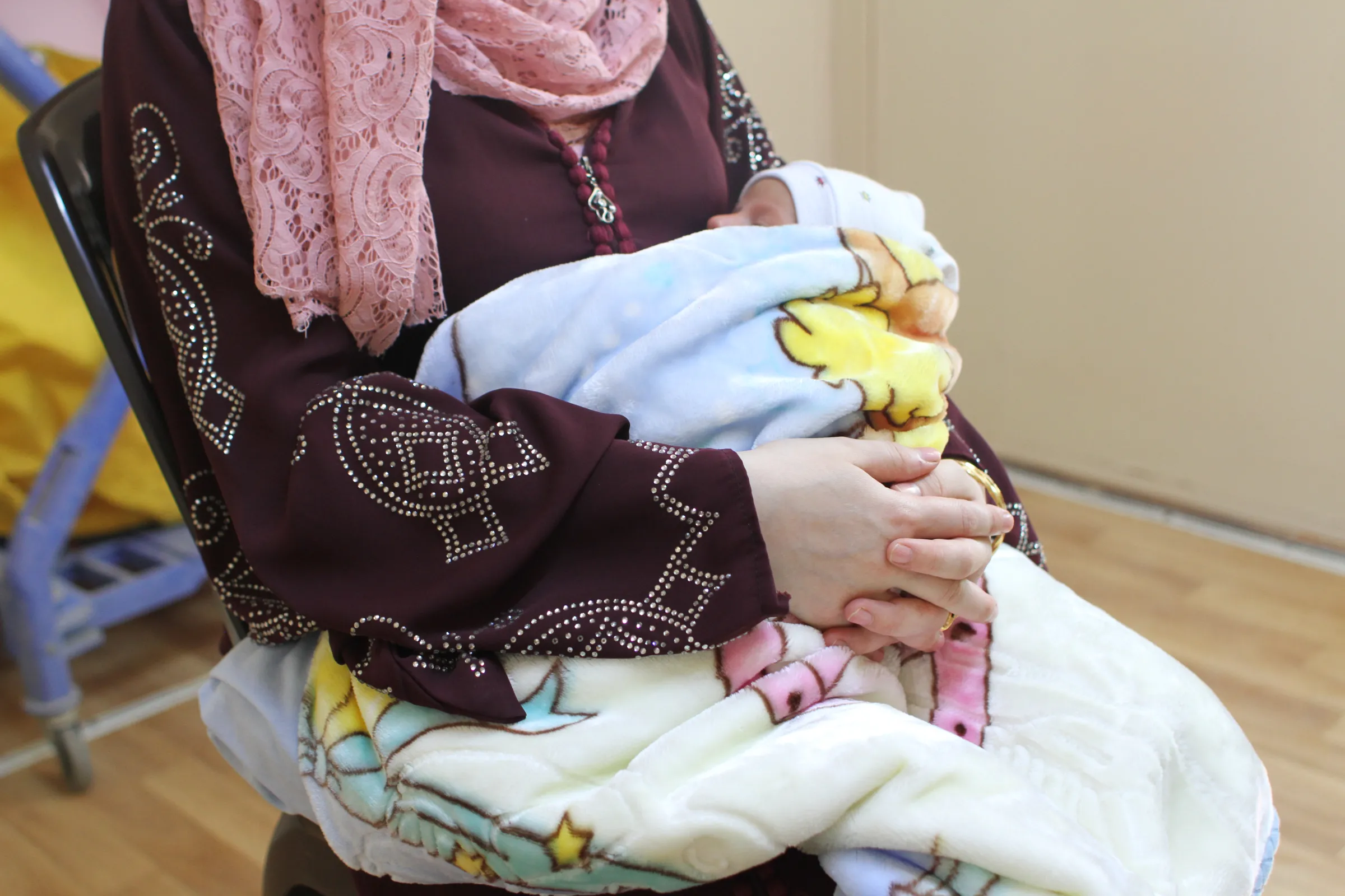Syrian woman Rana, 21, holds her newborn baby at a maternity clinic in the Zaatari refugee camp near the border city of Mafraq, Jordan, 17 October 2022