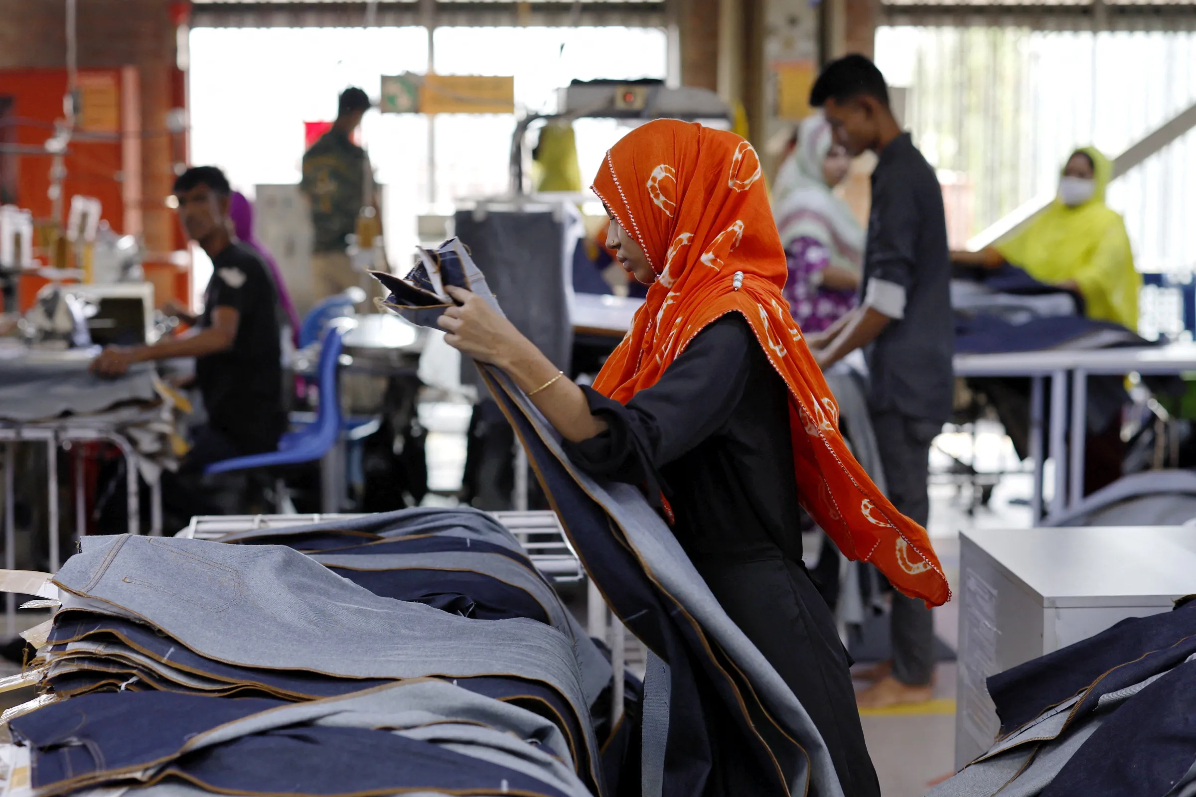 A Bangladeshi female garment worker checks sewing quality as she works in the sewing section of a factory in Gazipur, Bangladesh, April 9, 2025. REUTERS/Mohammad Ponir Hossain