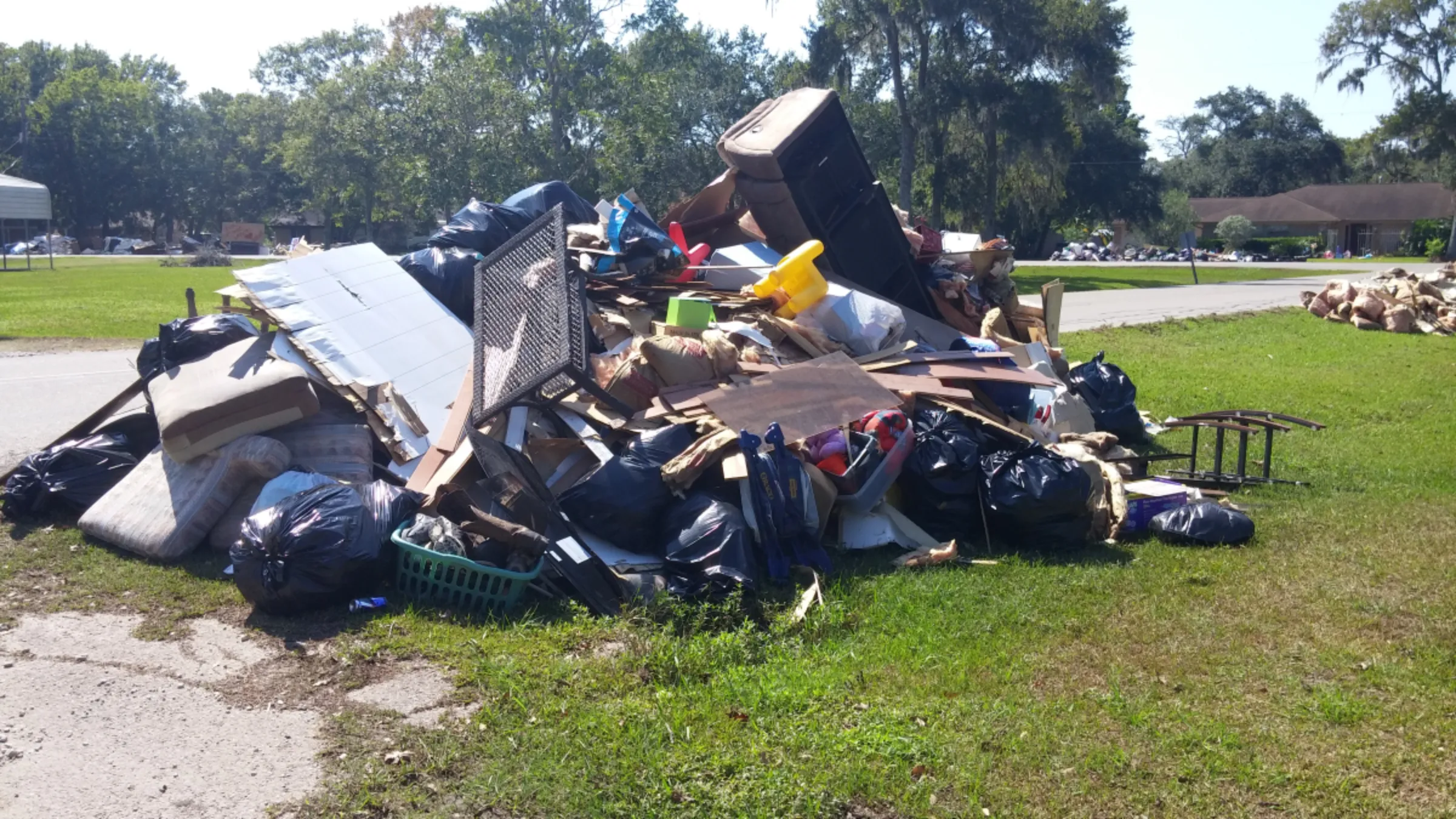 A trash pile outside of Kevin McKinney’s home, after Hurricane Harvey, is pictured in Richwood, Texas, USA, in 2017. Kevin McKinney/Handout via Thomson Reuters Foundation.