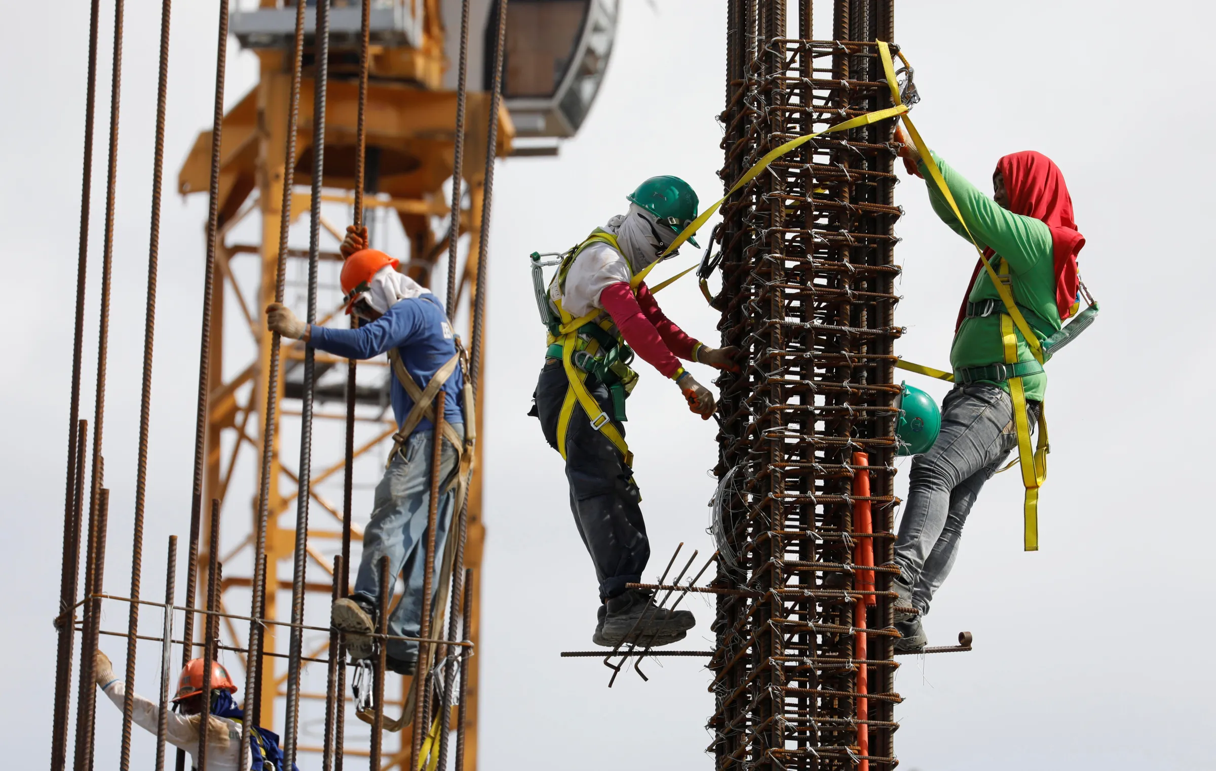 Construction workers are pictured at the construction site of an apartment building in Pasay, Metro Manila in the Philippines