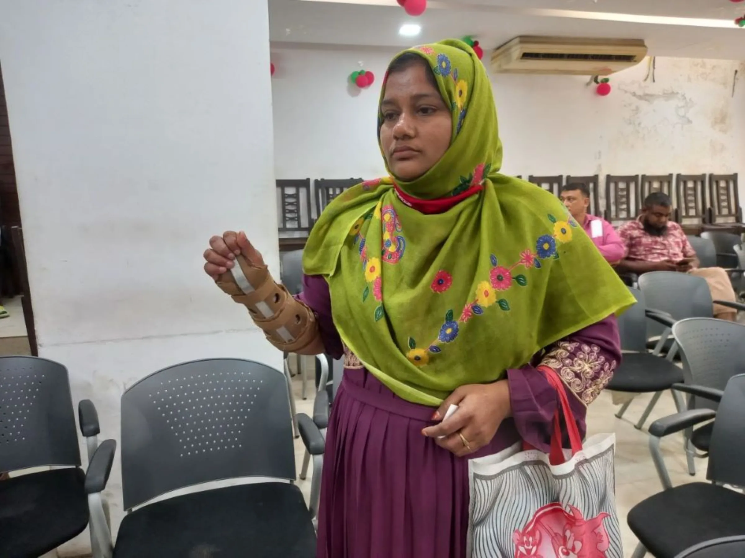 Shila Begum, a Rana Plaza survivor shows an injury during a meeting organised by National Garment Workers Federation in Dhaka, Bangladesh, April 18, 2023. Begum still needs regular medical care