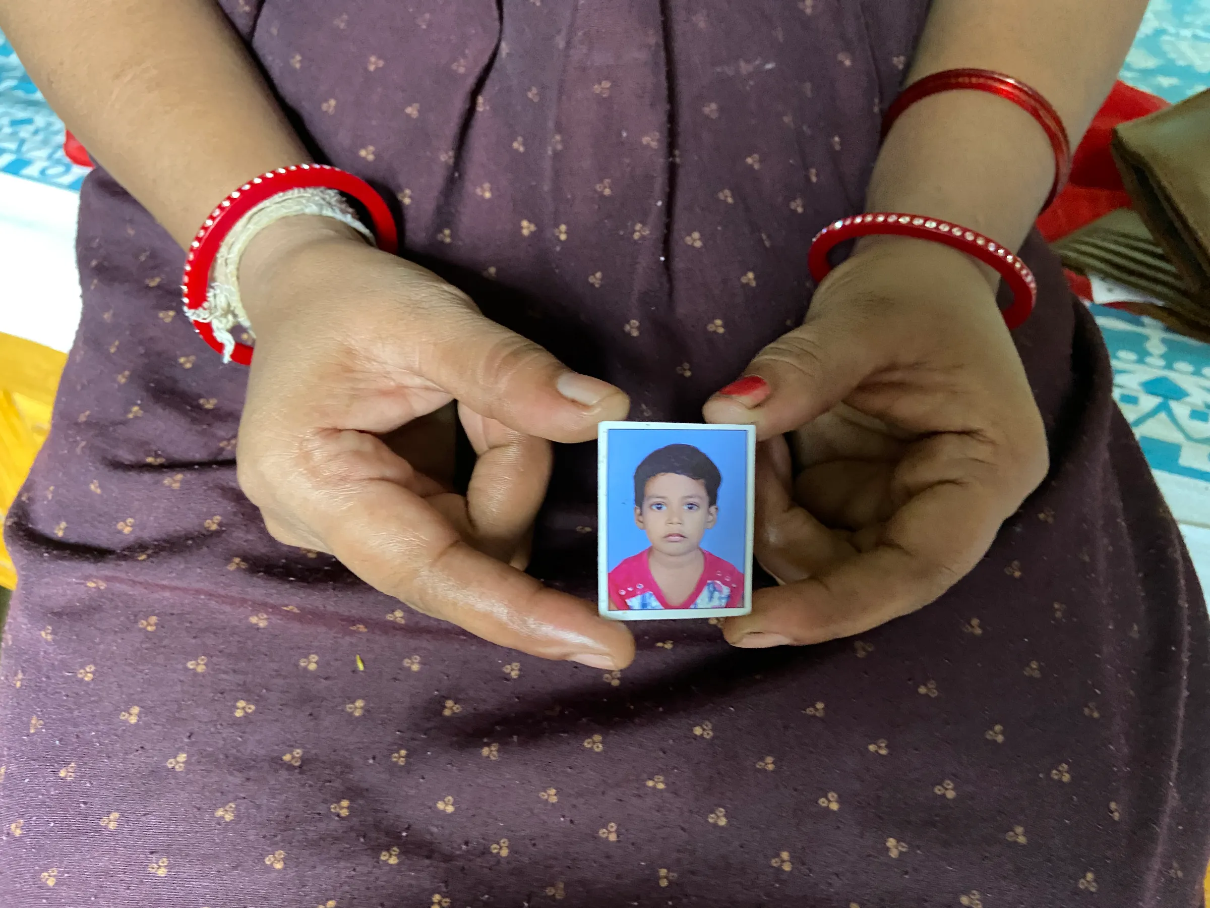 Nisha Umashankar Dandekar shows the picture of her five-year-old daughter who died in a leopard attack last year in Chandrapur, India, August 19, 2021