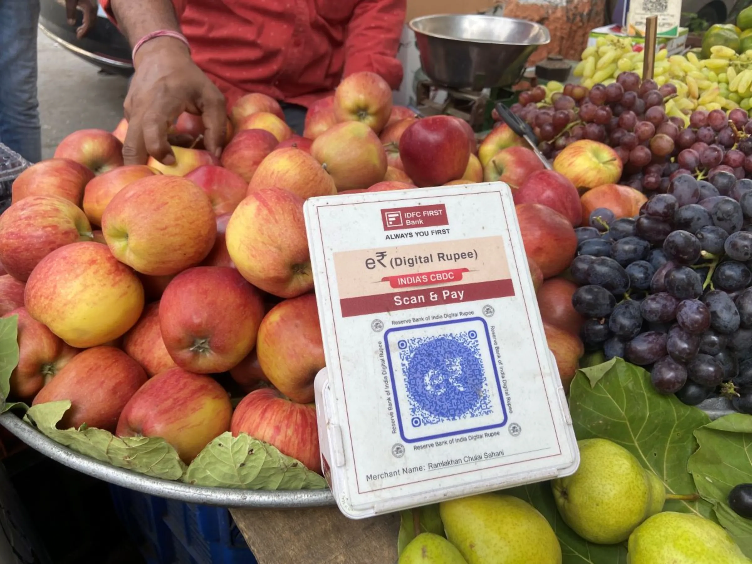 A transaction code for the Reserve Bank of India’s digital rupee placed at a fruit seller Bachche Lal Sahani’s cart in Mumbai, India, March 2, 2023. Thomson Reuters Foundation/Roli Srivastava