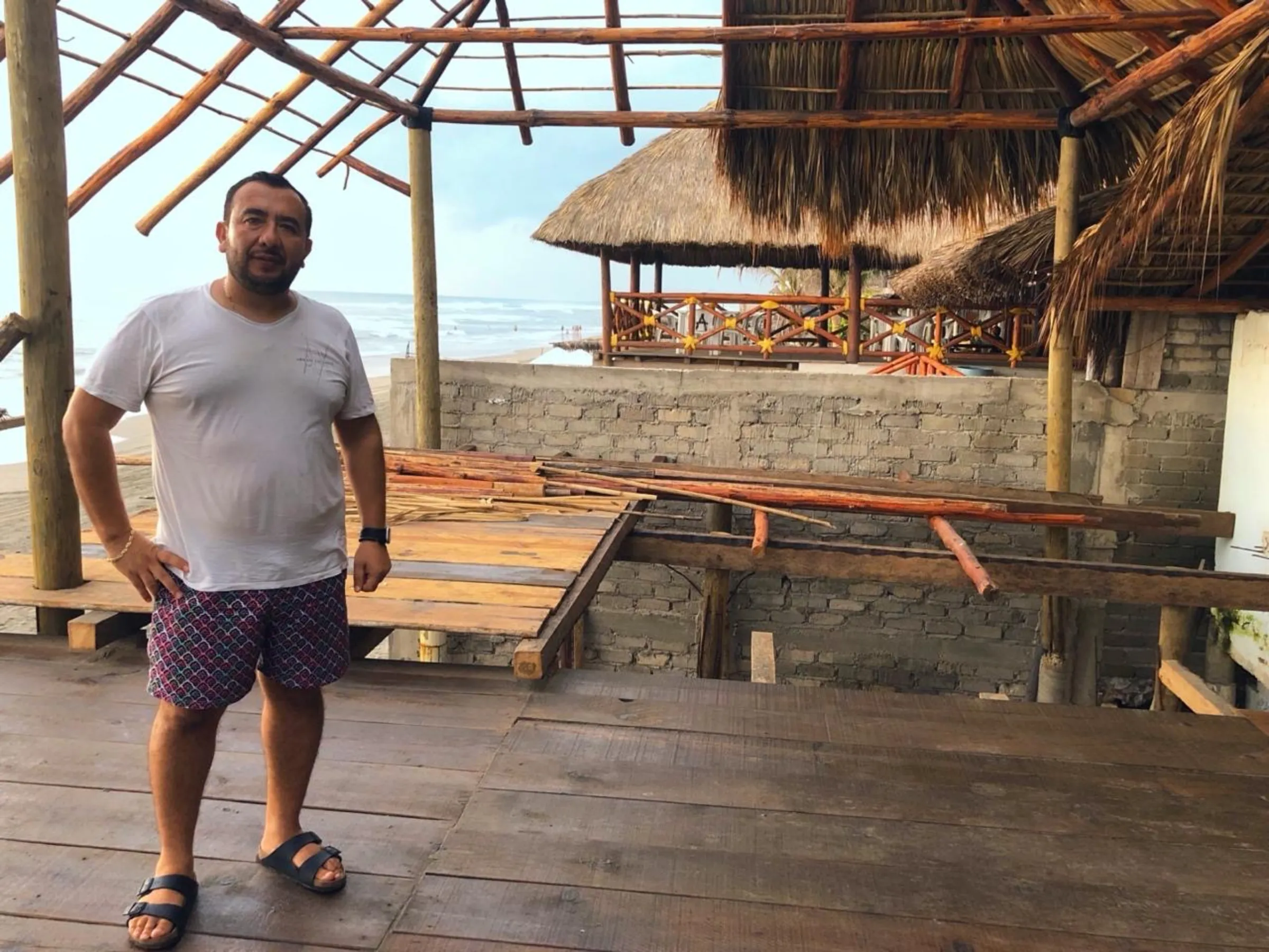 Small-business owner Salvador Bucio stands next to a hole caused by Hurricane Otis at his beach house in Acapulco, Mexico, July 27, 2024. Thomson Reuters Foundation/Diana Baptista