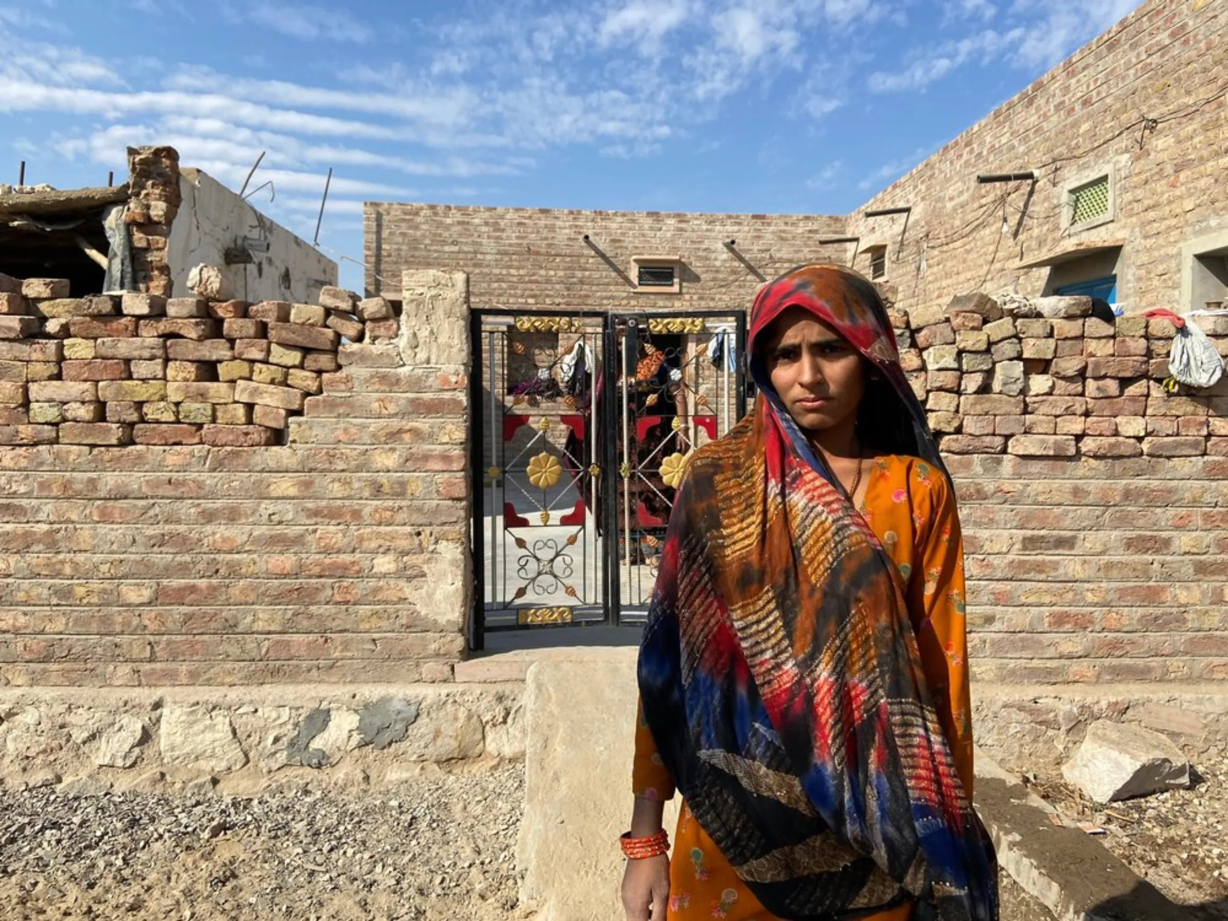 Teenager Hira Bano poses for a picture in front of her house near Bhadla Solar Park, Rajasthan, India, December 12, 2021