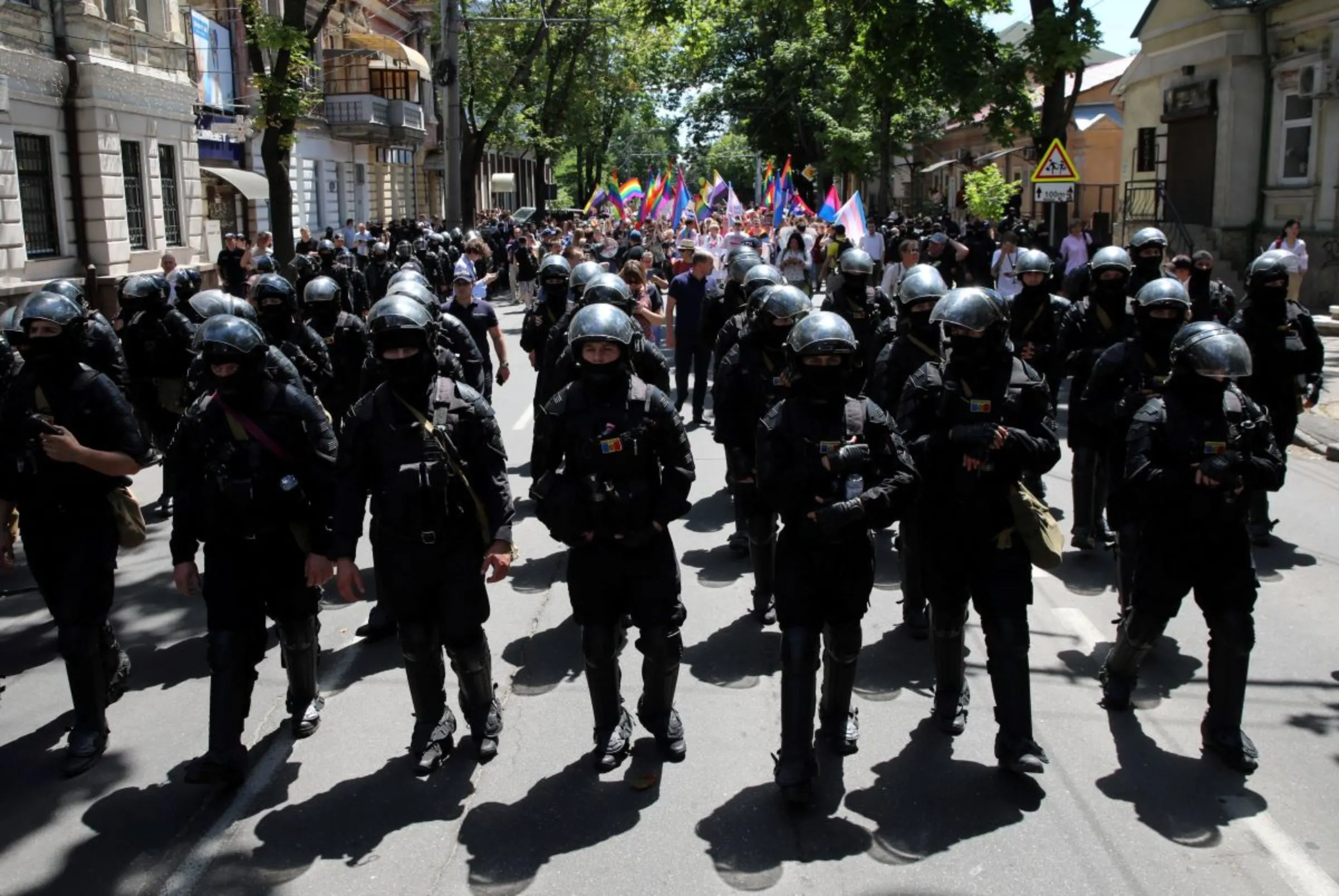 Law enforcement officers walk ahead of participants during the LGBT Pride march in Chisinau, Moldova June 19, 2022. REUTERS/Vladislav Culiomza