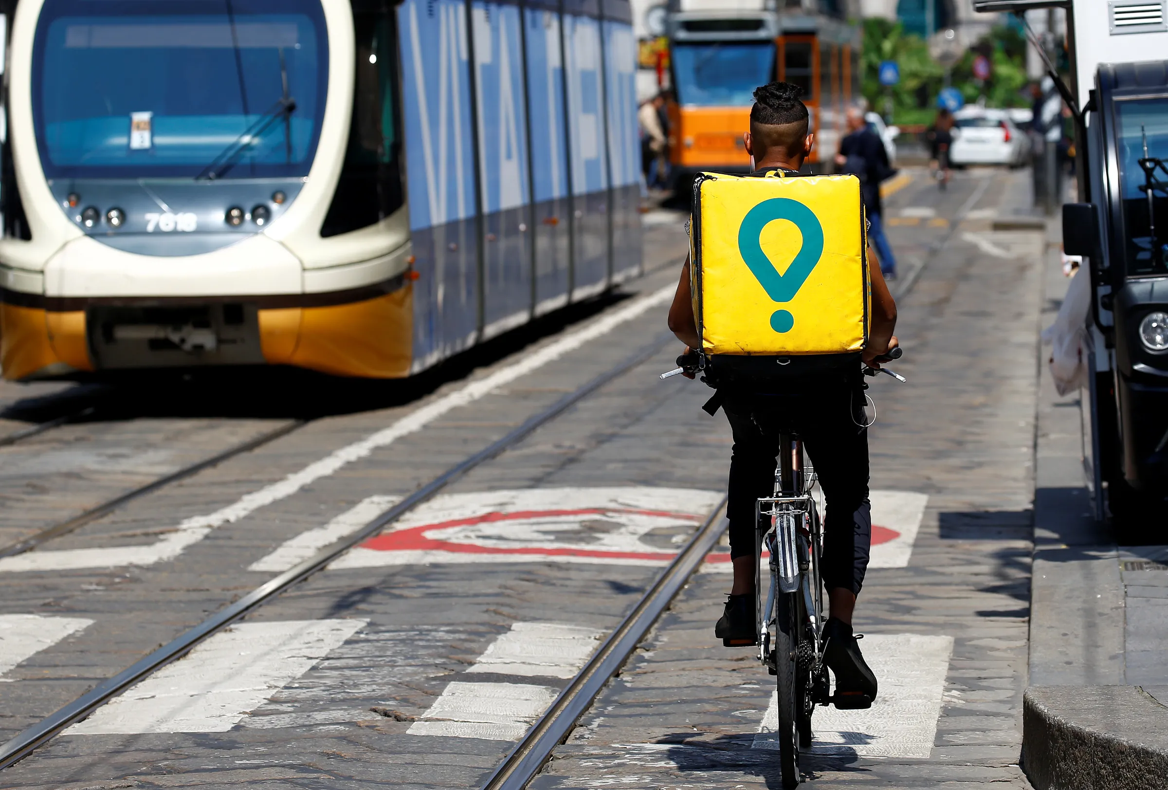 A delivery driver for Glovo cycles in downtown Milan, Italy, May 18, 2018. REUTERS/Stefano Rellandini