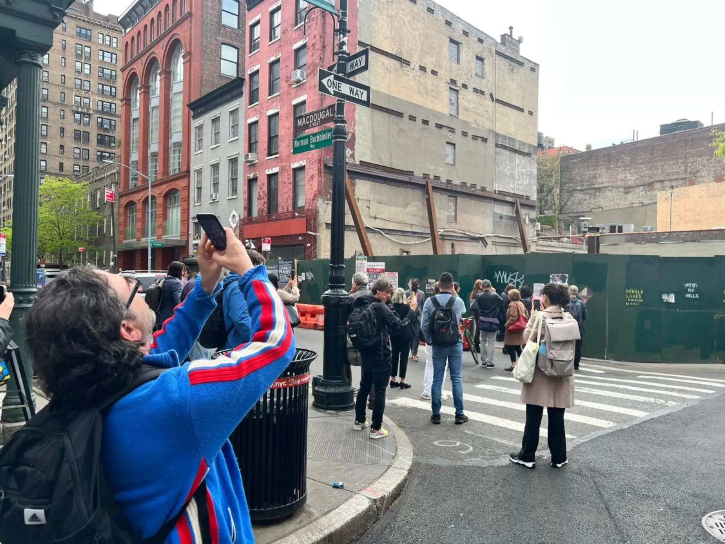 People use their phones to look at augmented-reality images of proposed construction in Manhattan, New York in April 2023. inCitu/Handout via Thomson Reuters Foundation