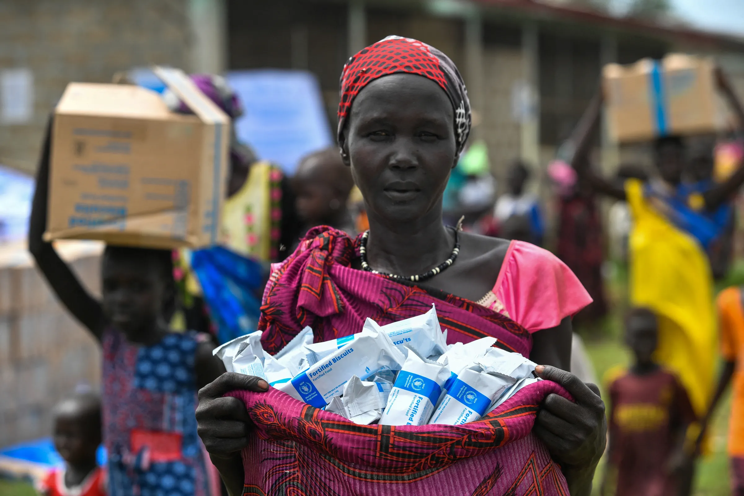 A South Sudanese asylum seeker carries fortified biscuits received as part of WFP food assistance at the Matar refugee camp in Gambella region, Ethiopia June 12, 2025. Michael Tewelde/WFP/Handout via REUTERS