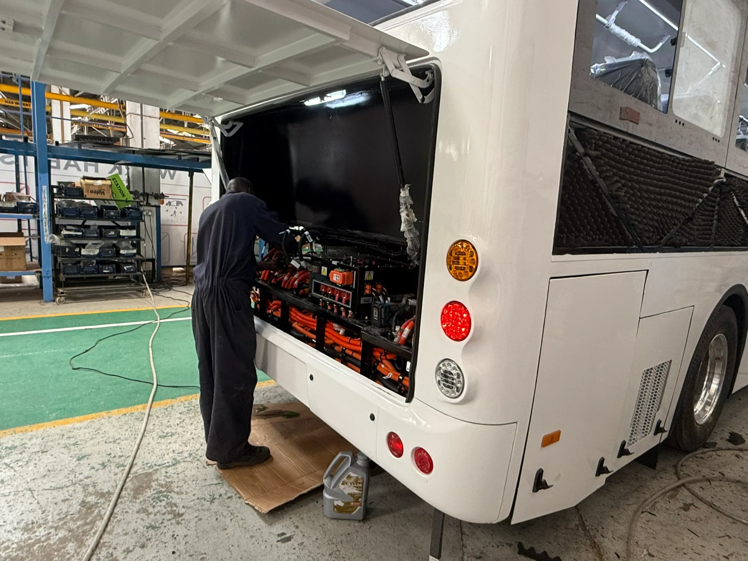 An employee for Kenyan electric bus firm BasiGo checks the battery of a newly assembled bus in Nairobi, Kenya on Nov. 5, 2024. Thomson Reuters Foundation/Nita Bhalla