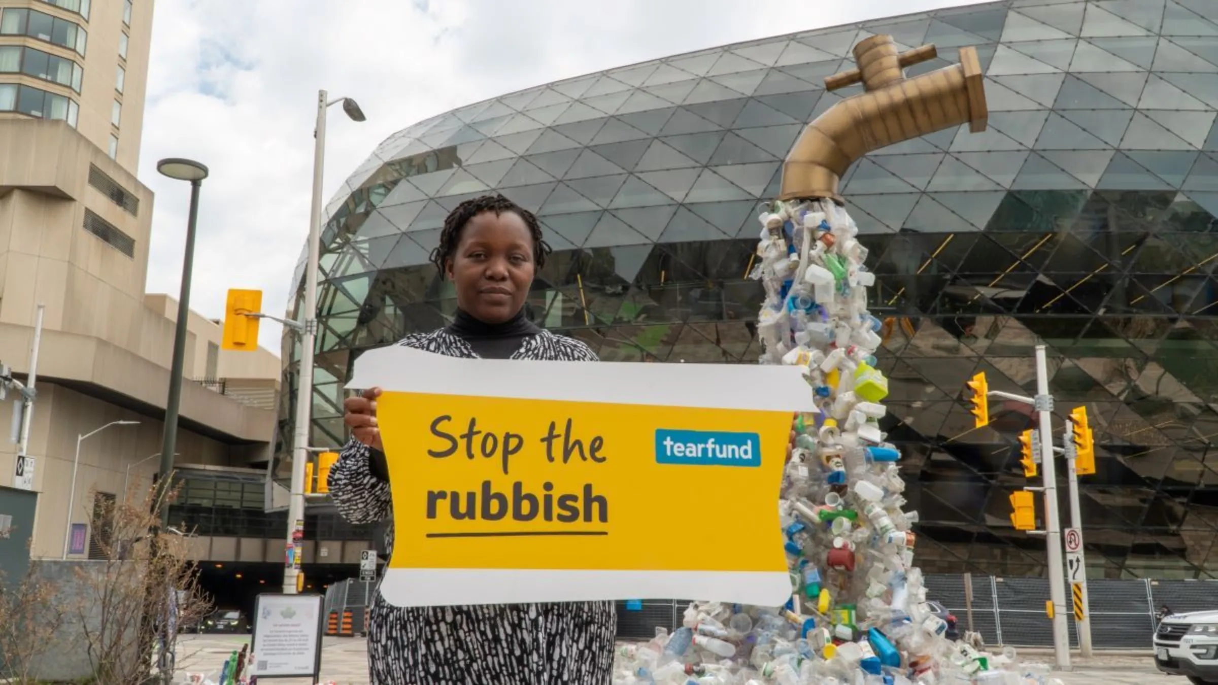 Malawian scientist and campaigner Tiwonge Mzumara-Gawa holds a sign outside INC4 U.N. plastic treaty negotiations in Ottawa, Canada. April 28, 2024. Adam Aucock/Tearfund/Handout via Thomson Reuters Foundation