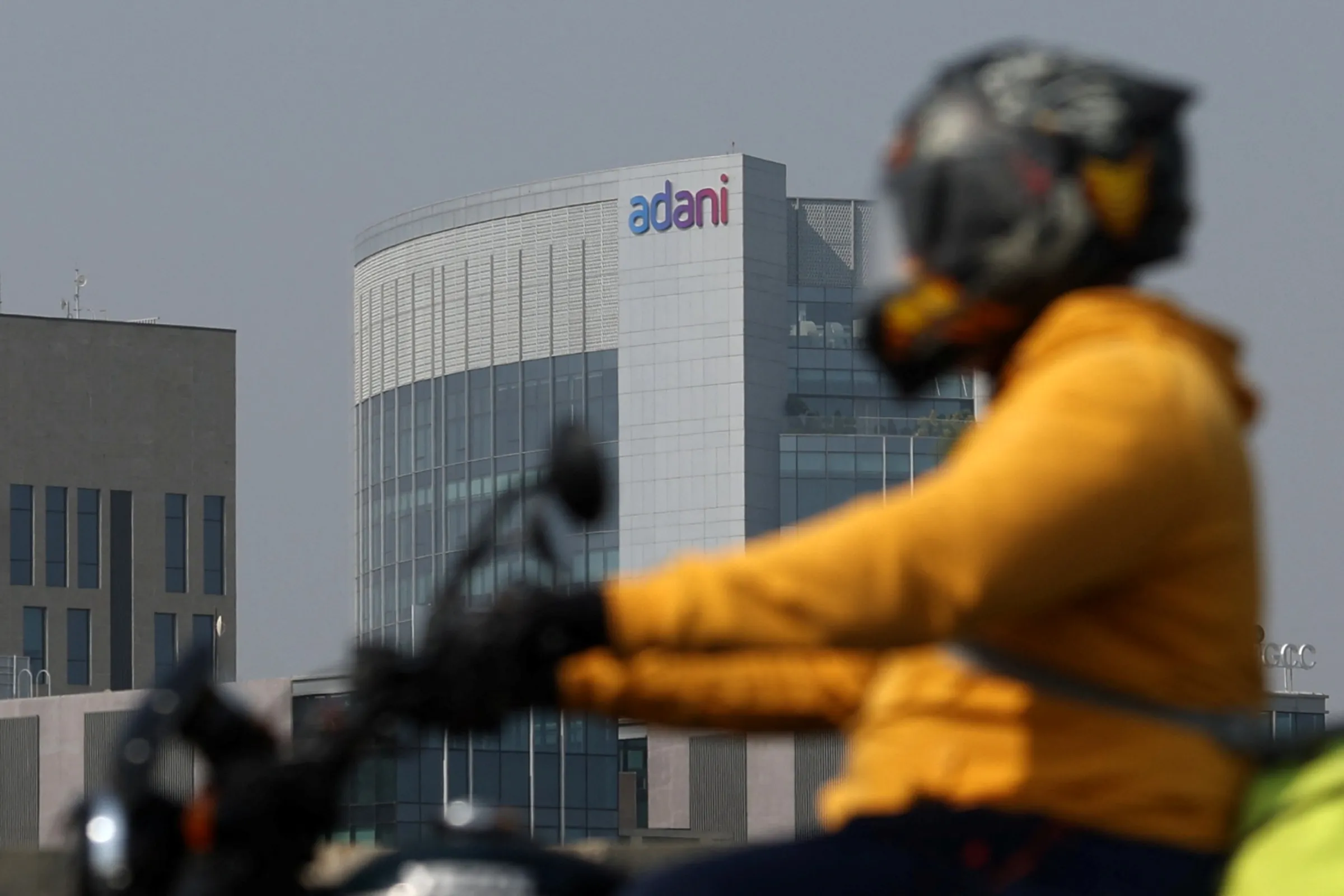 A man rides his motorbike in the outskirts of Ahmedabad, India, November 21, 2024. REUTERS/Amit Dave