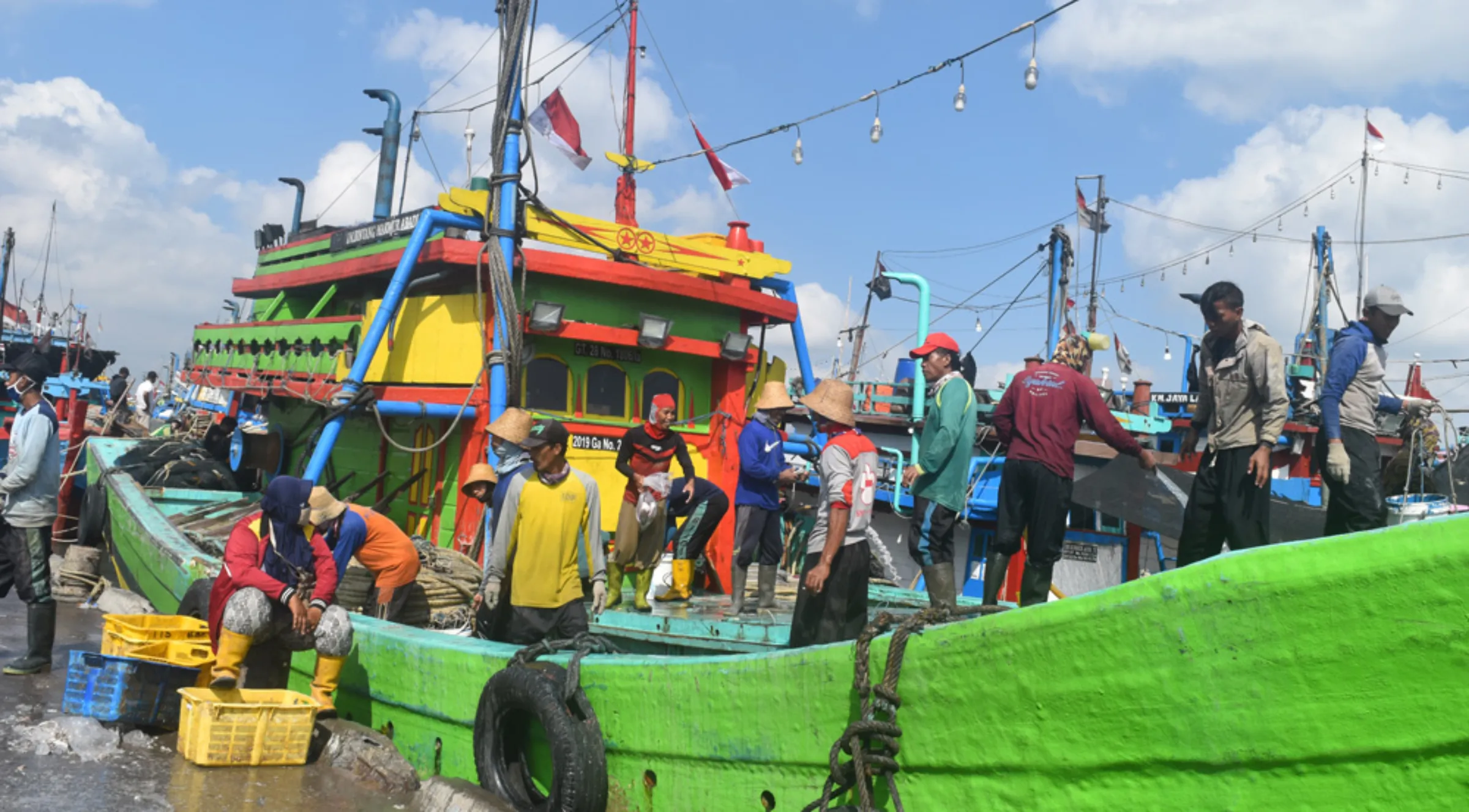 A boat crew cleans up after unloading the day’s catch at the port of Tasikagung, in Central Java, Indonesia, August 12, 2022