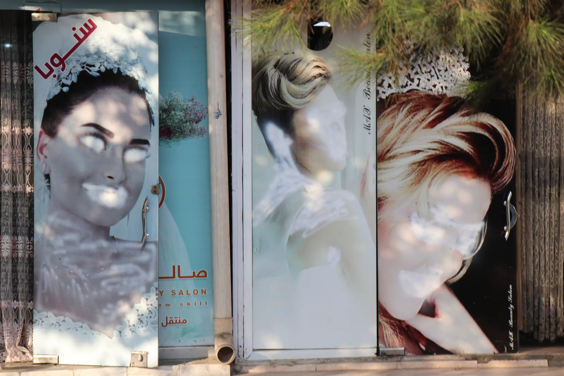 Images of women on a beauty salon/beauty salons are seen painted over in Kabul in a photo taken September 2021.