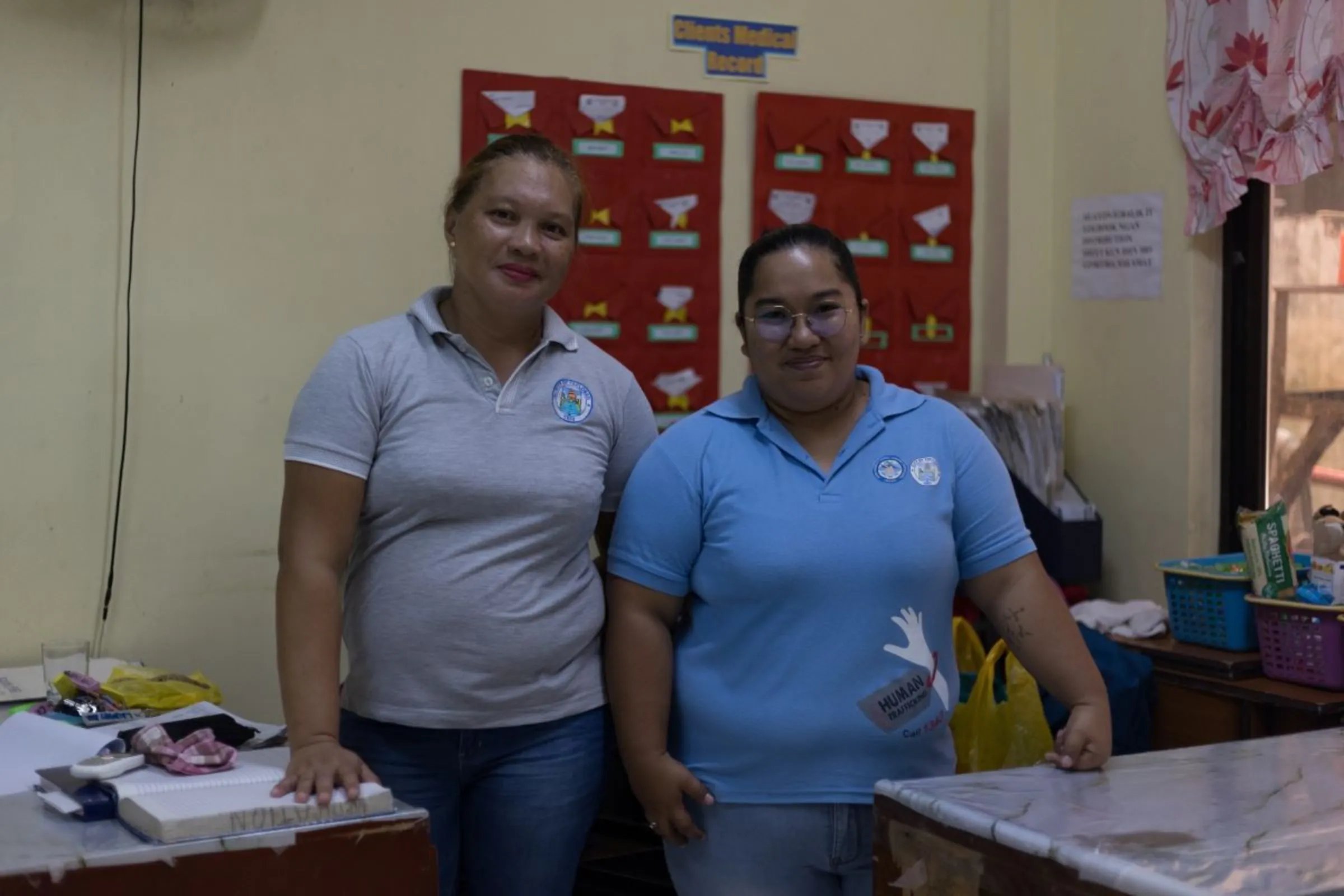 Social worker Jerimae Coringcoting (right) poses with a house parent inside the shelter (left), Tacloban City, Philippines. October 9, 2023. Thomson Reuters Foundation/Kathleen Limayo