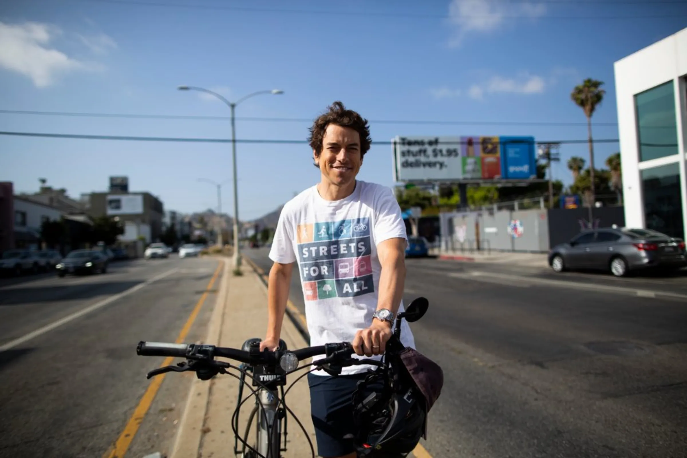 Michael Schneider, a cycling activist and founder of Streets for All, stops his bicycle along a median in West Hollywood, Los Angeles, May 19, 2021