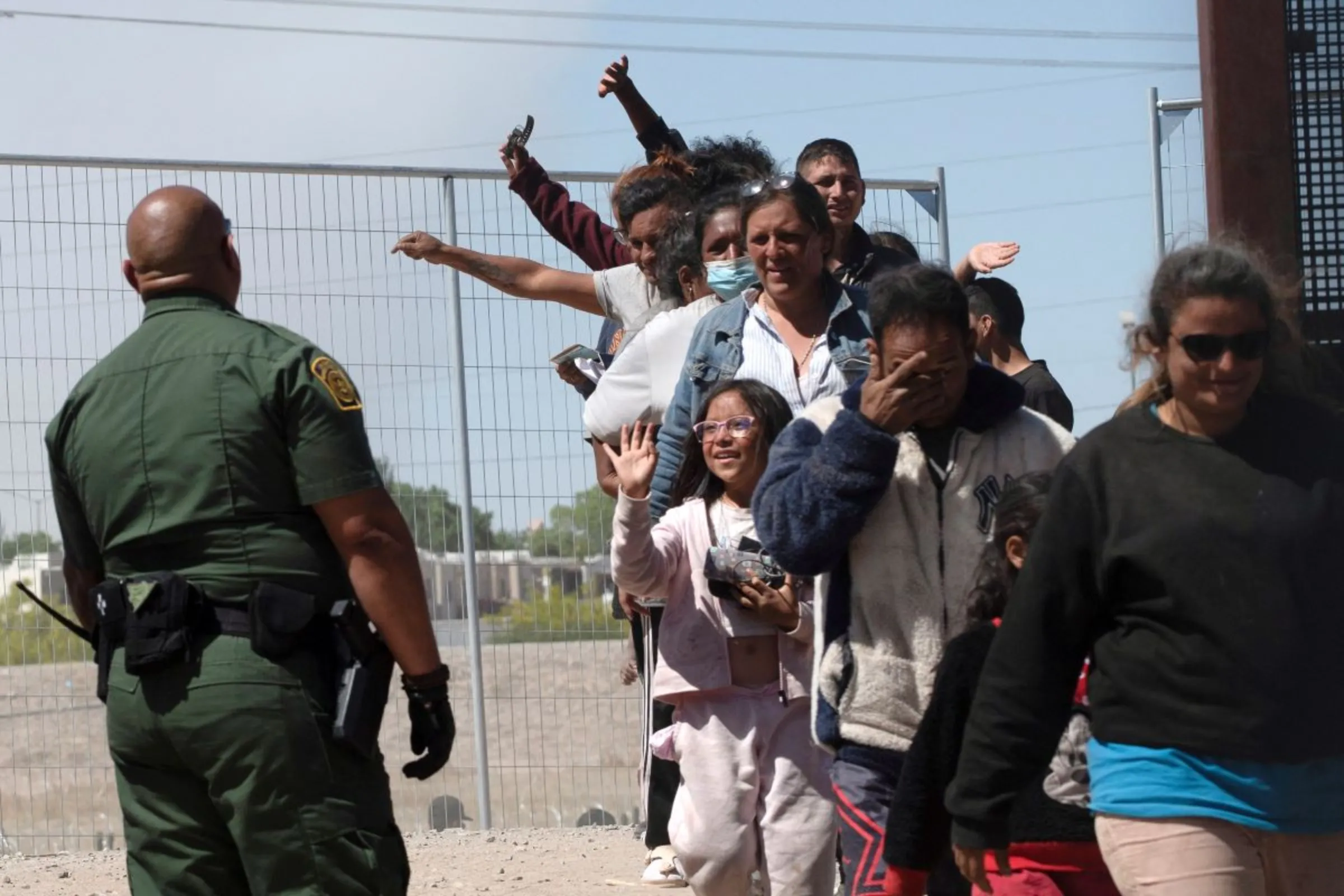 Migrants from Venezuela wave goodbye as they are taken to a CBP processing center in El Paso, Texas, U.S., May 10, 2023. REUTERS/Roberto Schmidt