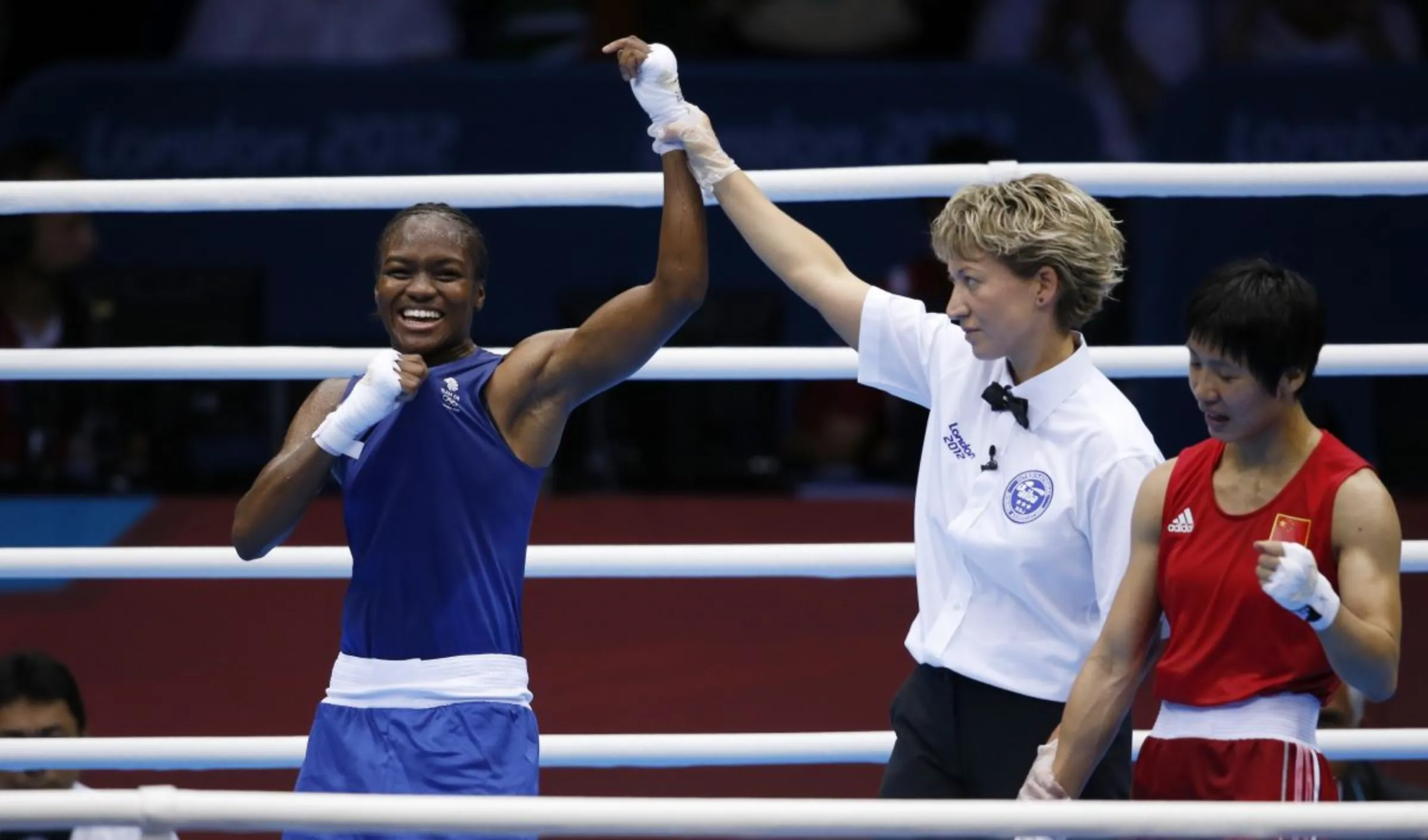 Britain's Nicola Adams (L) reacts as she is declared the winner over China's Ren Cancan during their Women's Fly (51kg) gold medal boxing match at the London Olympic Games August 9, 2012. REUTERS/Damir Sagolj