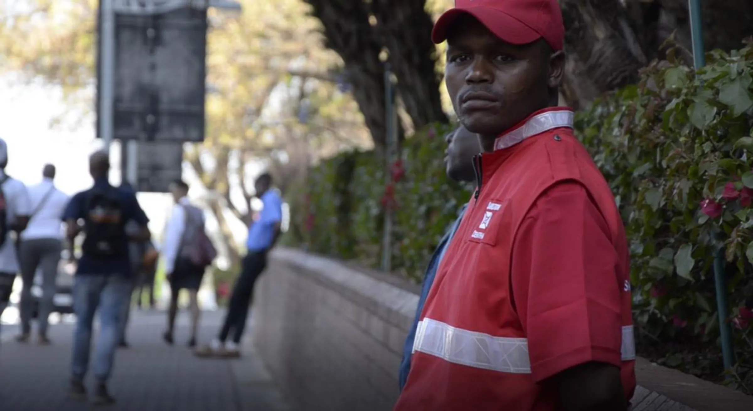 A security guard leans against a wall in Sandton in Johannesburg, South Africa, 8 October 2019. Thomson Reuters Foundation/Kim Harrisberg