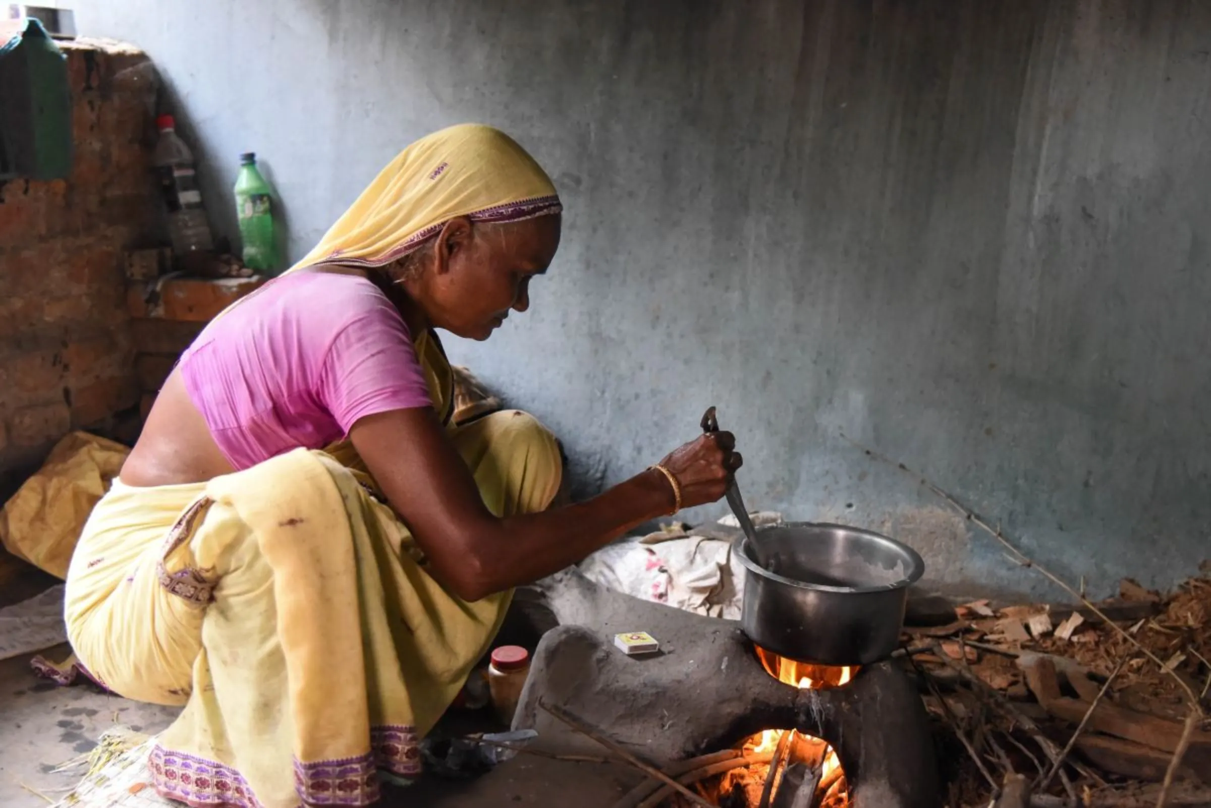 Farmer Bhanumati Mahanta prepares a millet dish at her home in Kaurikala village, India, on July 12, 2023. Thomson Reuters Foundation/Tanmoy Bhaduri