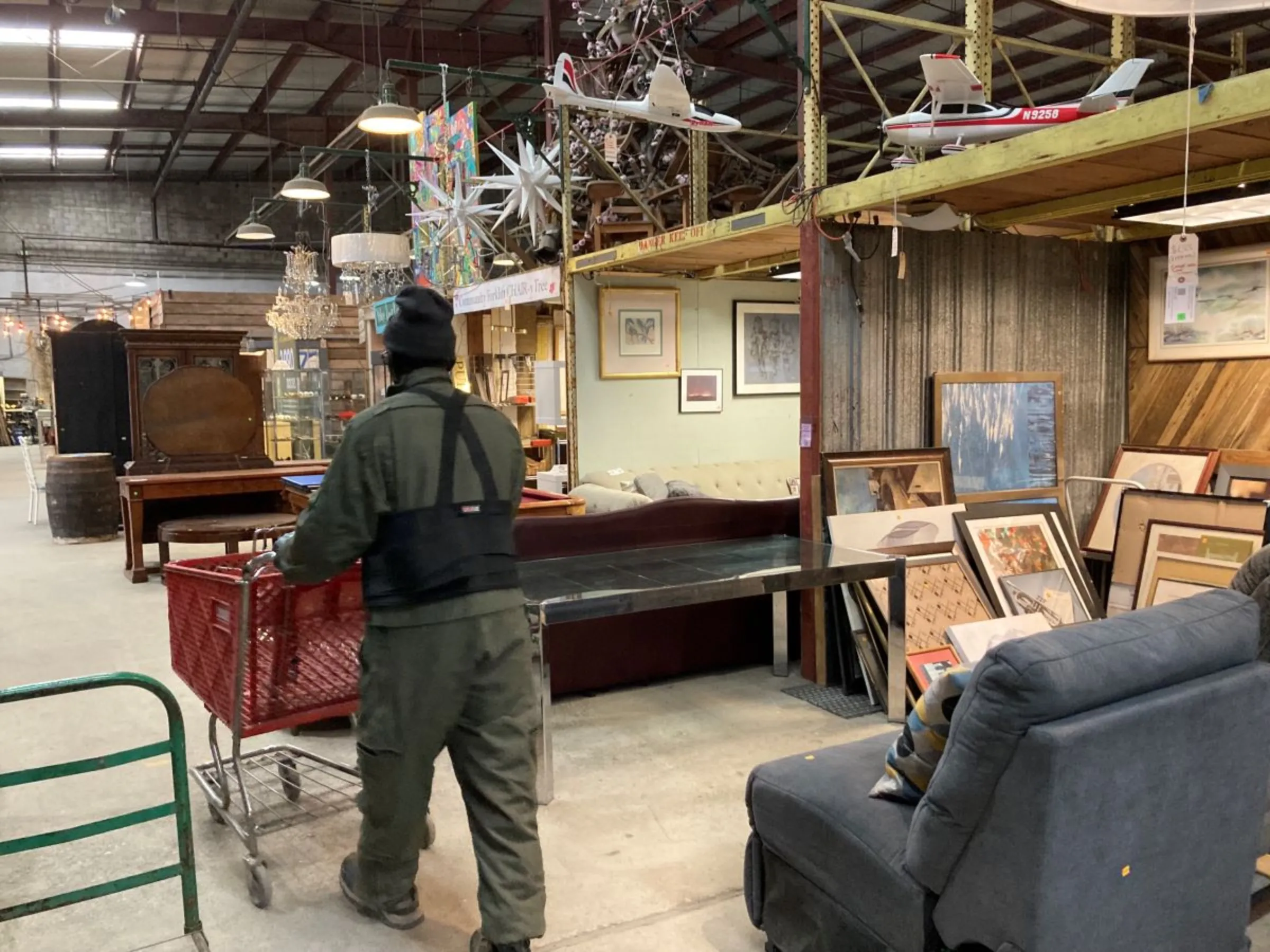 A man peruses a reuse store in Edmonston, Maryland, on March 13, 2023. Thomson Reuters Foundation/Carey L. Biron