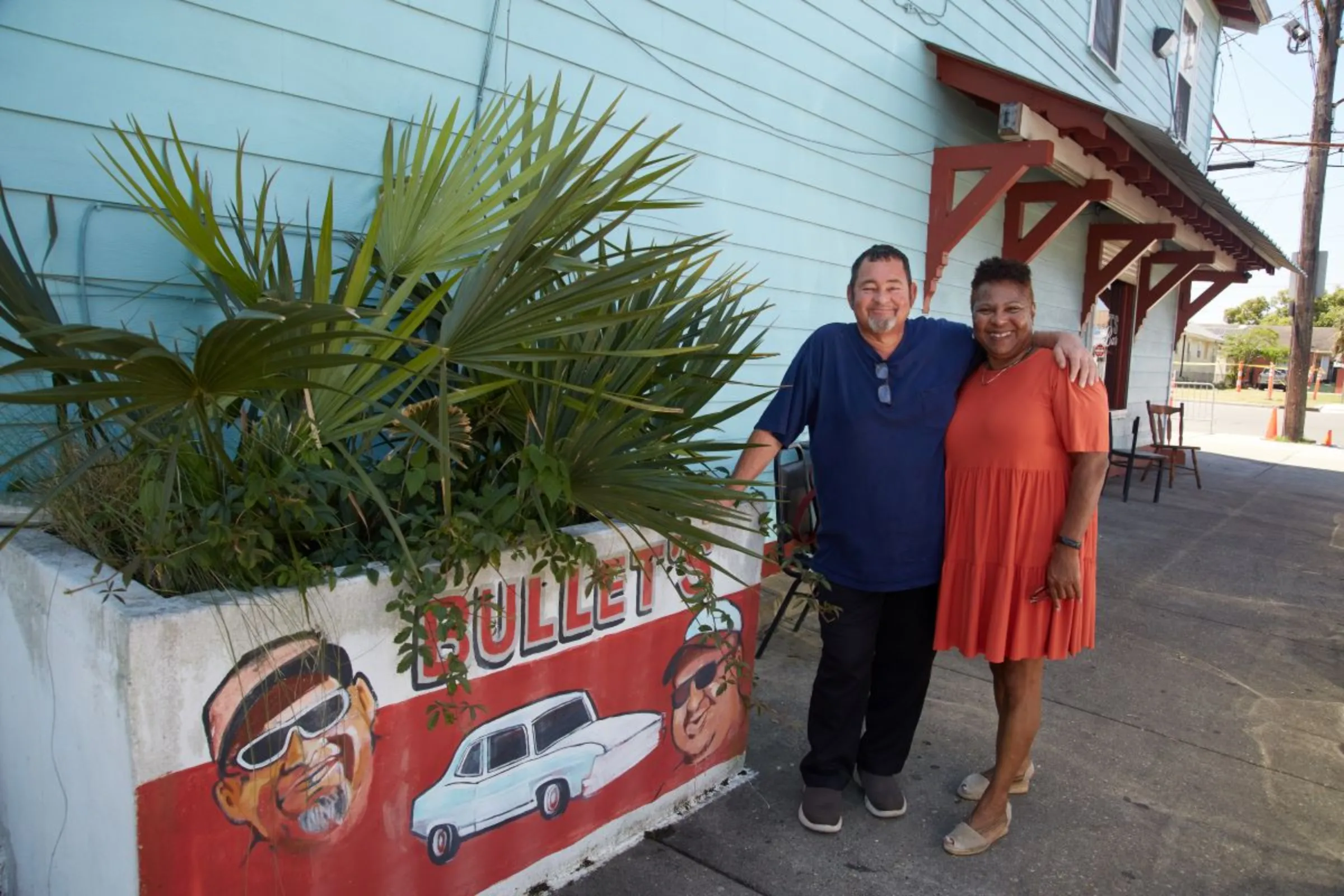 Rollin Garcia, owner of Bullet’s Sports Bar, and Angela Chalk, executive director of Healthy Community Services, pose next to a planter box outside Garcia’s bar in New Orleans, Louisiana, USA, April 19, 2023
