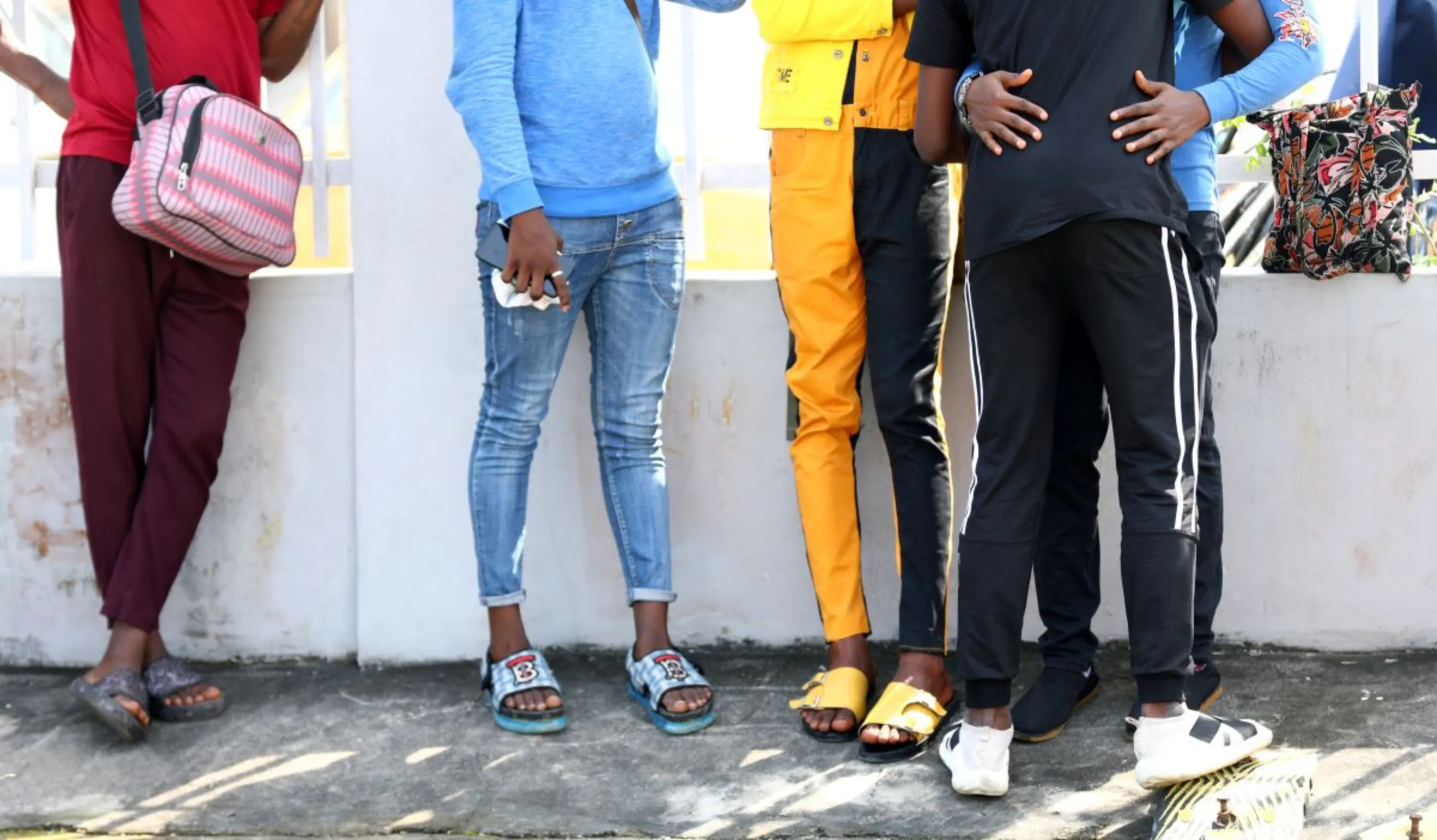 Men charged with public displays of affection with members of the same sex gather outside a court in Lagos, Nigeria October 27, 2020. REUTERS/Temilade Adelaja