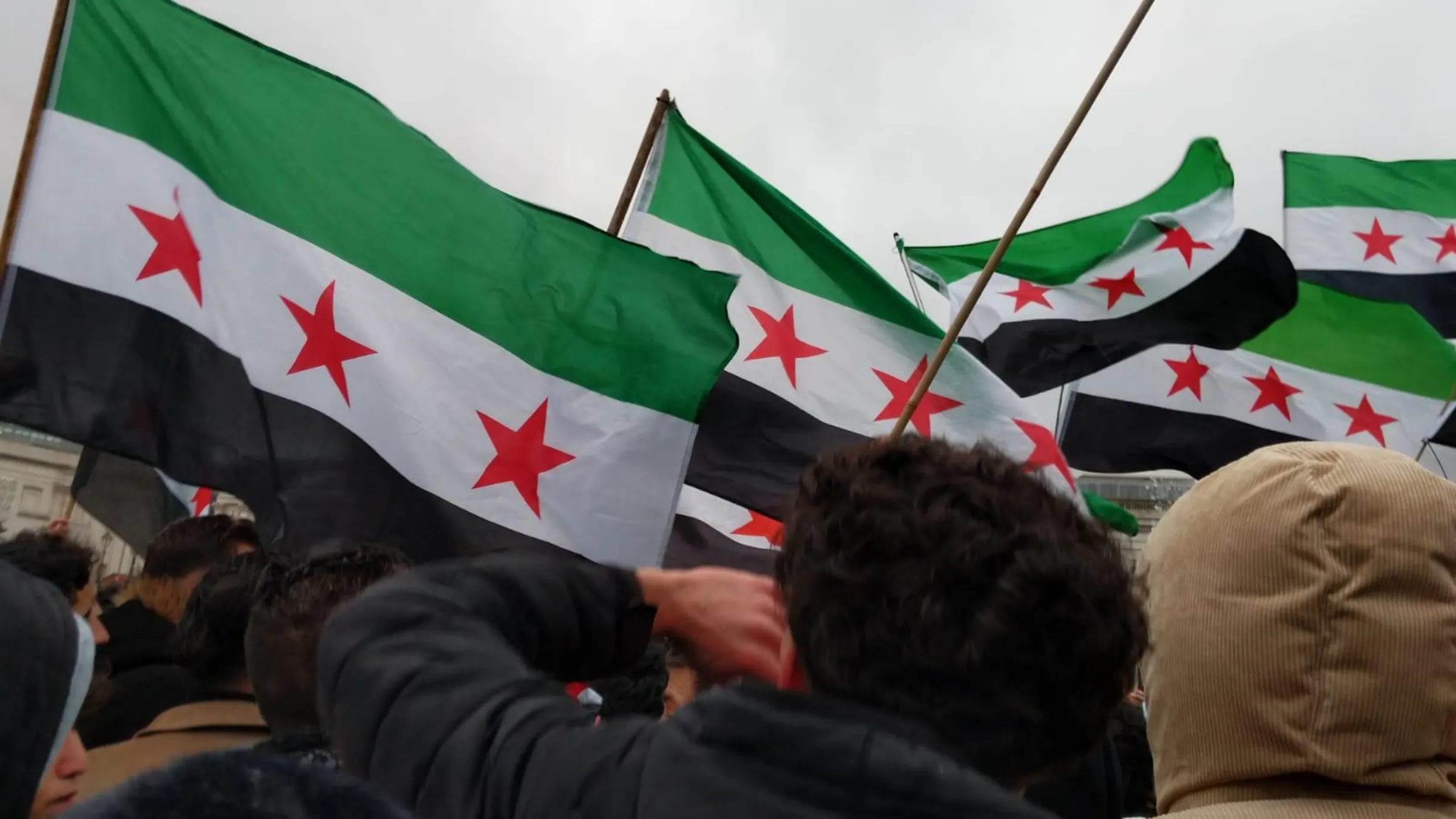 Syrians living in Britain wave flags as they celebrate the overthrow of Syria's President Bashar al-Assad in London's Trafalgar Square on Dec 9, 2024. Hanna Bakhash/Handout via Thomson Reuters Foundation