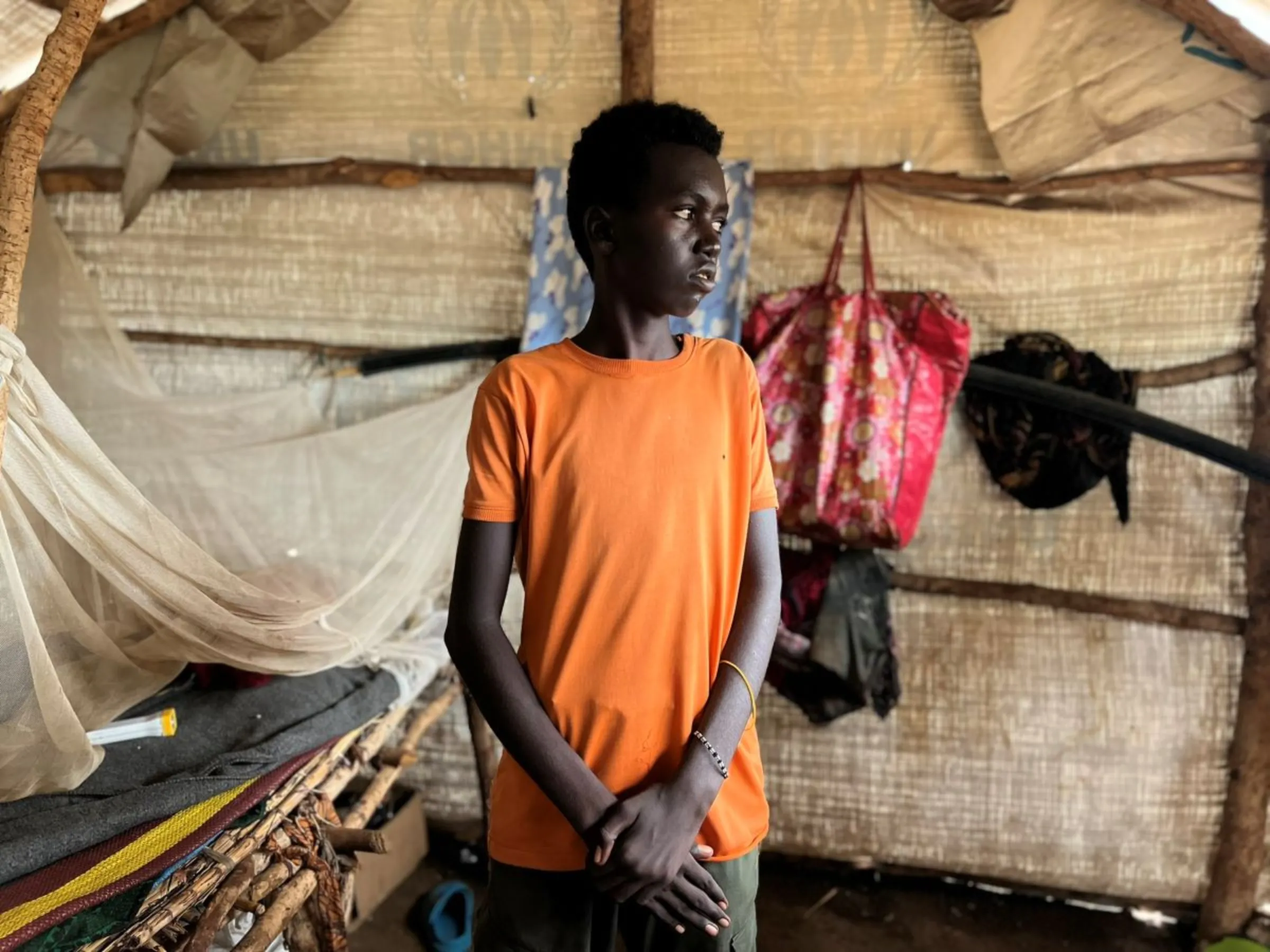 Ali, 14, poses for a picture in his tent in Kaya refugee camp in Maban county, South Sudan on July 30, 2024. Ali is one of hundreds of Sudanese children who became separated from their families as a result of the conflict in neighbouring Sudan. Thomson Reuters Foundation/Nita Bhalla