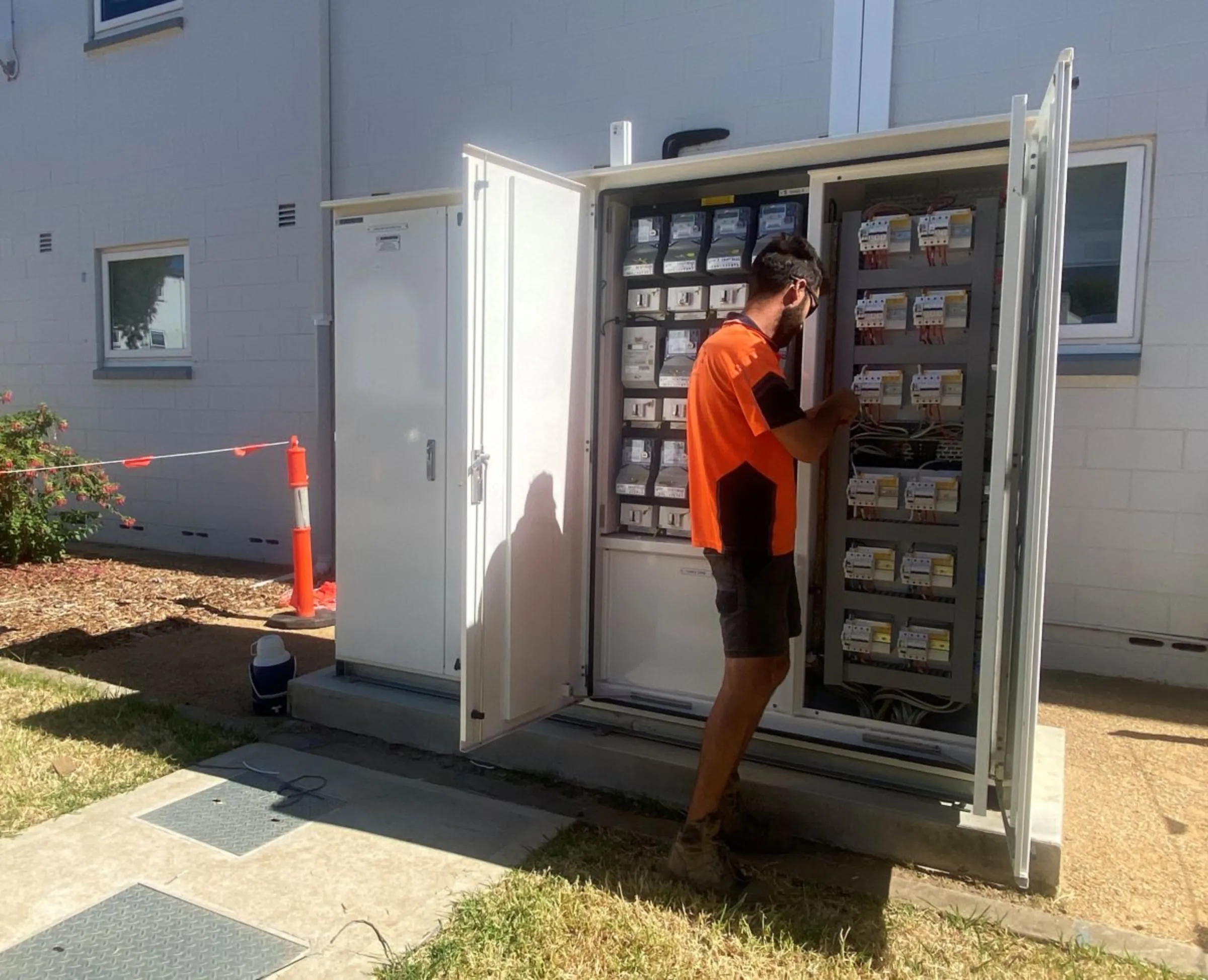 A worker with solar firm Suntrix checks on an installation of a solar energy system at a social housing block in Adelaide, Australia. January 23 2024. Thomson Reuters Foundation/Rina Chandran