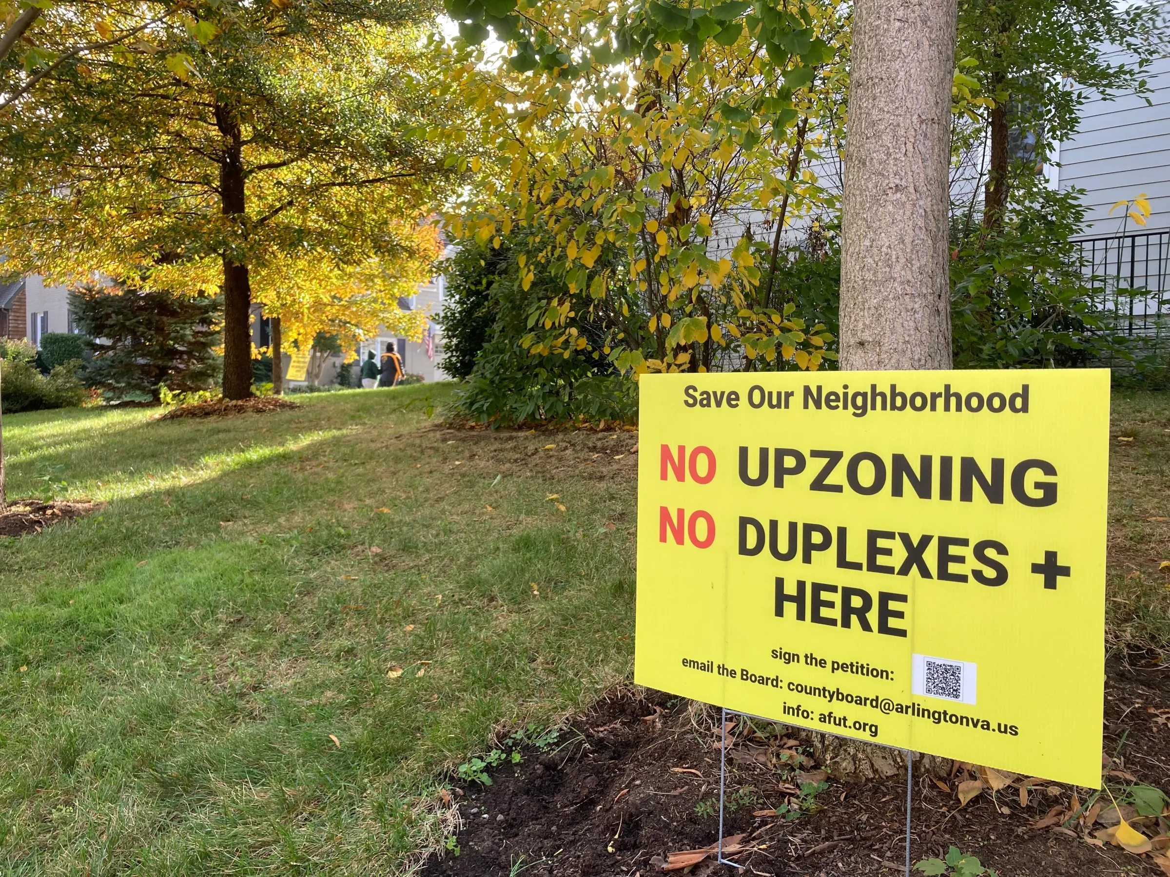 Yard signs oppose a proposal aimed at boosting housing options in Arlington, Virginia, in October. Thomson Reuters Foundation/Carey L. Biron