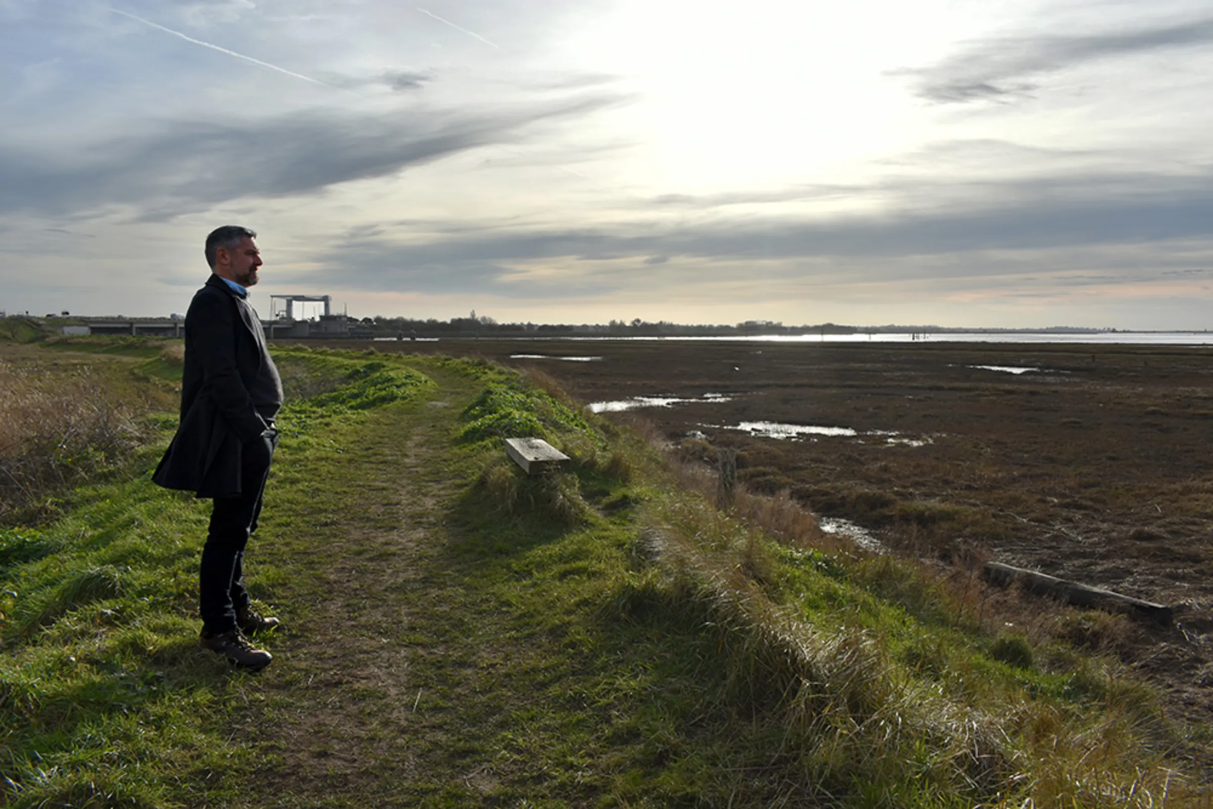 Broads resident and activist Duncan Holmes studies Breydon Water in the floodplain of the River Yare near Great Yarmouth, east England, February 10, 2023. Thomson Reuters Foundation/Rachel Parsons