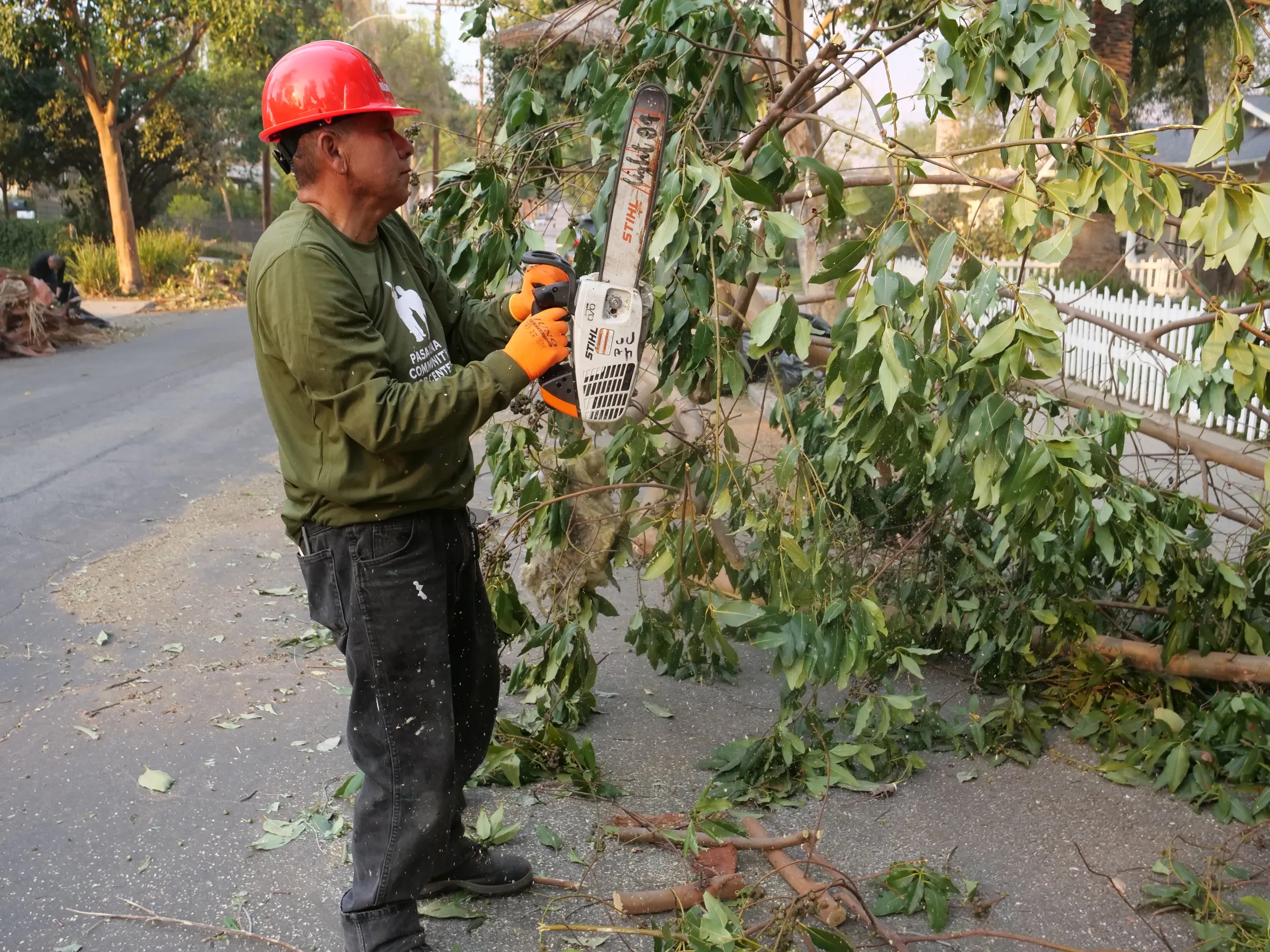Cesar, a migrant worker from Mexico, cuts trees in Pasadena, California, as part of post-wildfire clean-up efforts in January. NDLON/Handout via Thomson Reuters Foundation