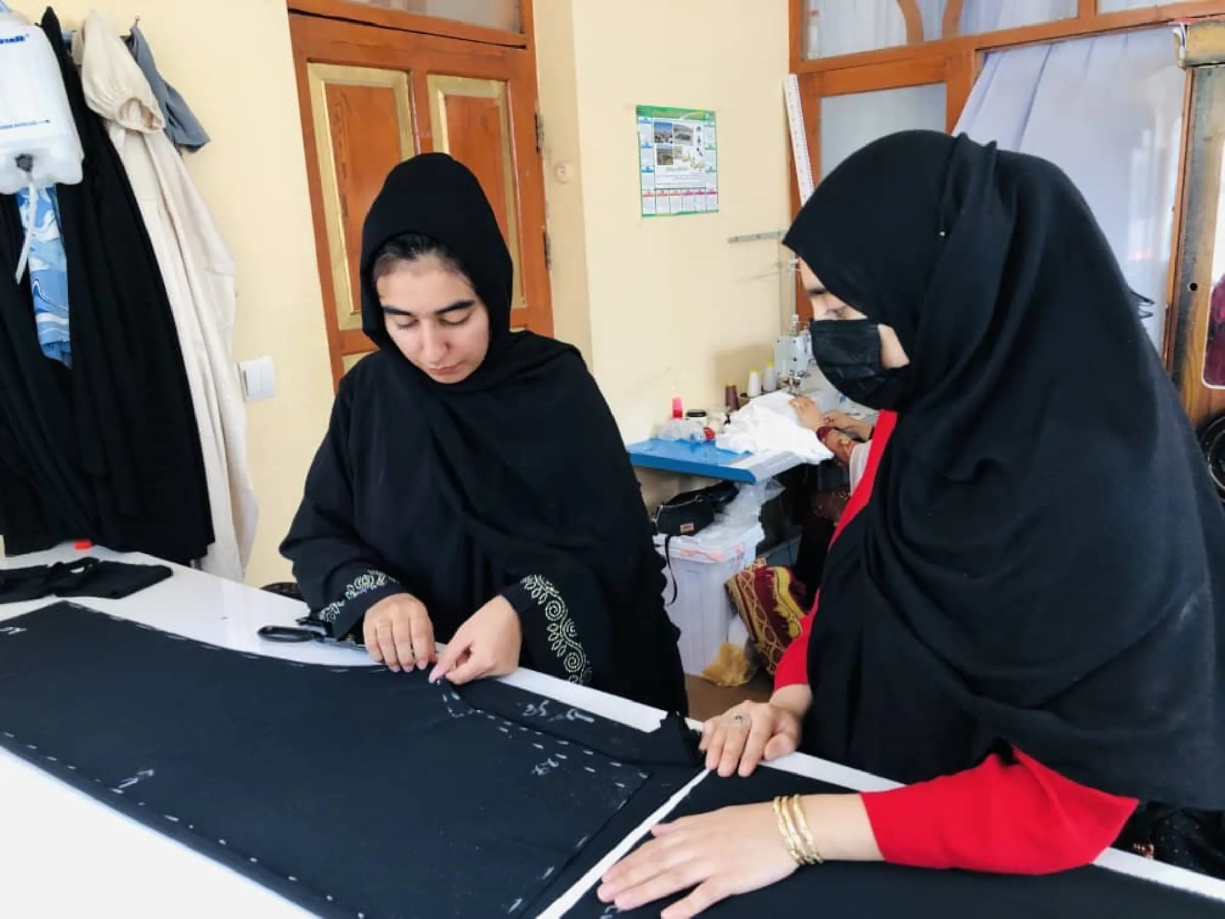 Tailor Wajiha Sekhawat works on a pattern at her home studio in Herat. Photo taken August 2023. Handout/Thomson Reuters Foundation