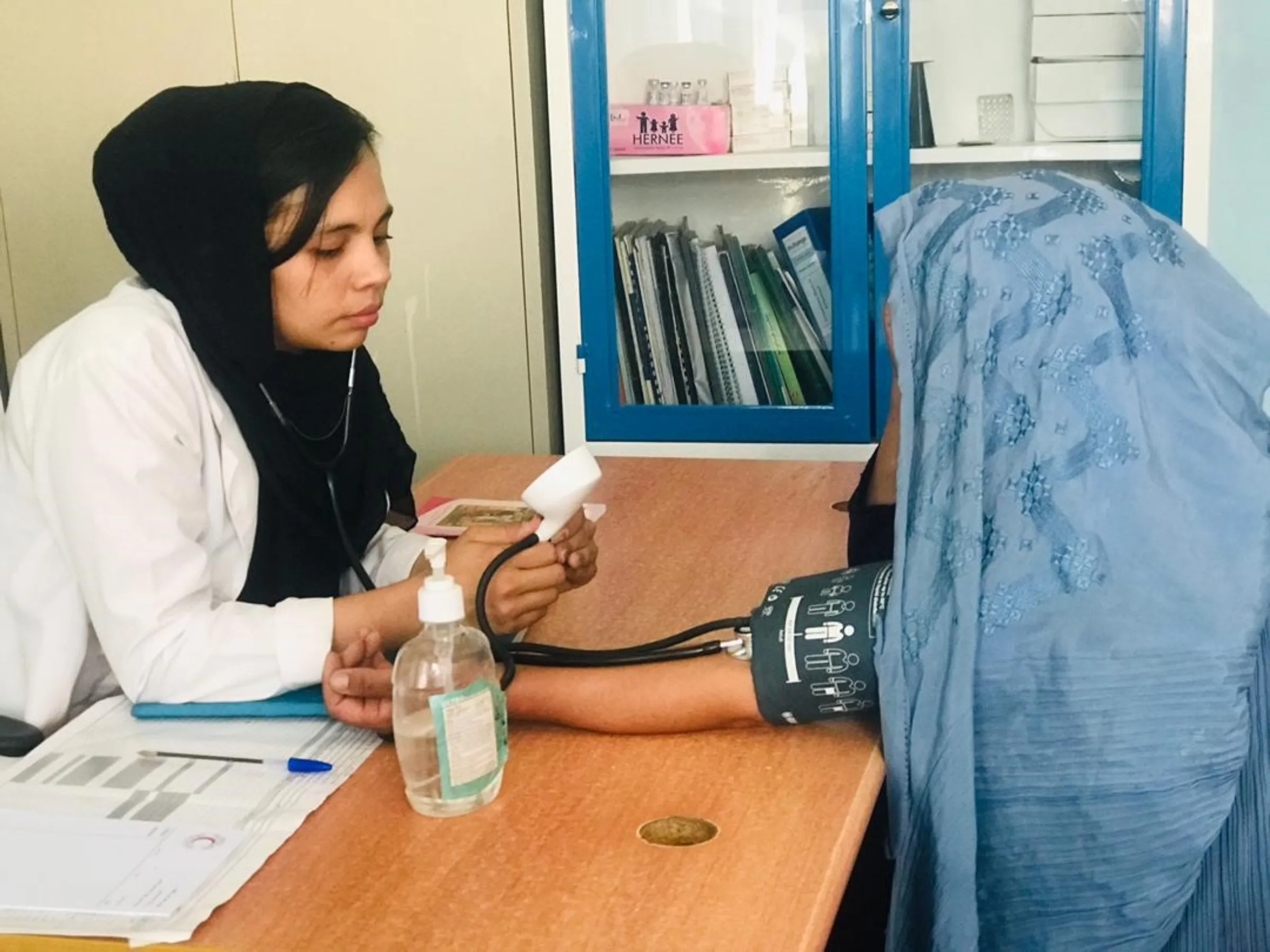 Midwife Parsila Azimi attends to a patient at a clinic in Herat, Afghanistan.  Photo taken August 2023
