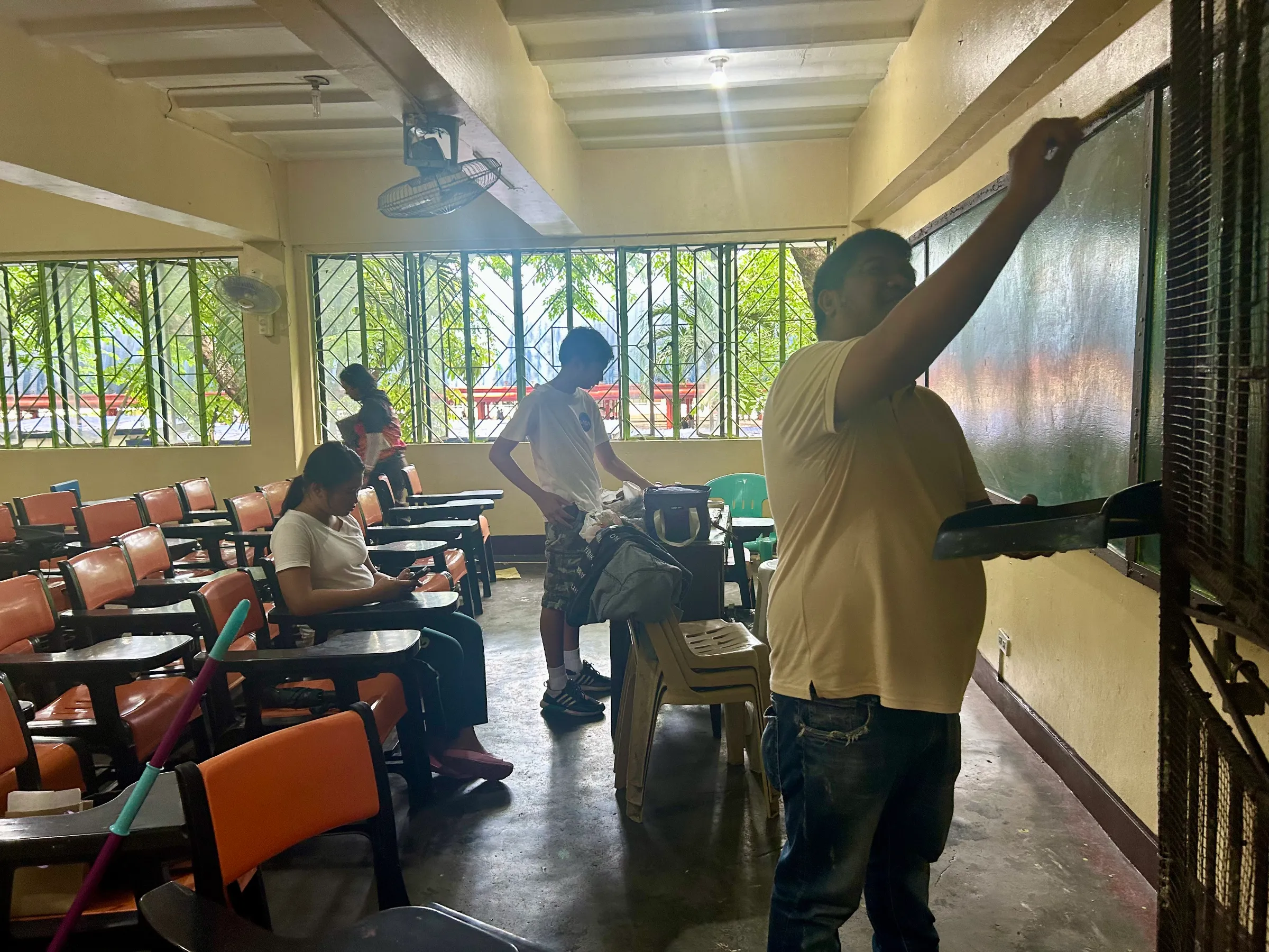 Parents, teachers and students volunteer to clean and repair classrooms a week before schools open in this school in Caloocan City, Philippines. June 13, 2025. Thomson Reuters Foundation/Mariejo Ramos