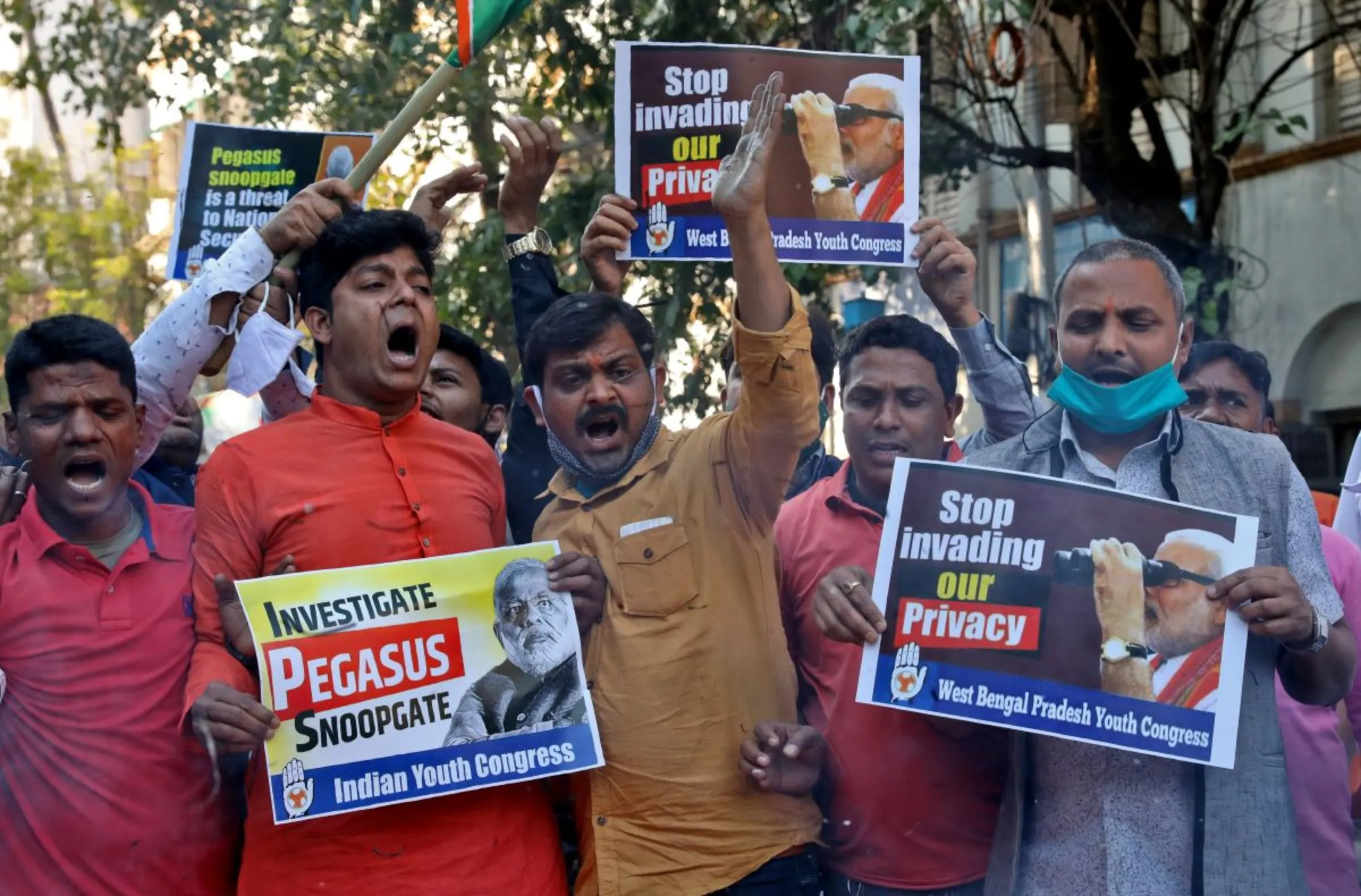 Supporters of India's main opposition Congress party hold placards as they shout slogans against India's Prime Minister Narendra Modi during a protest against what they say is use of Pegasus to spy on activists, journalists and politicians, in Kolkata, India, February 2, 2022