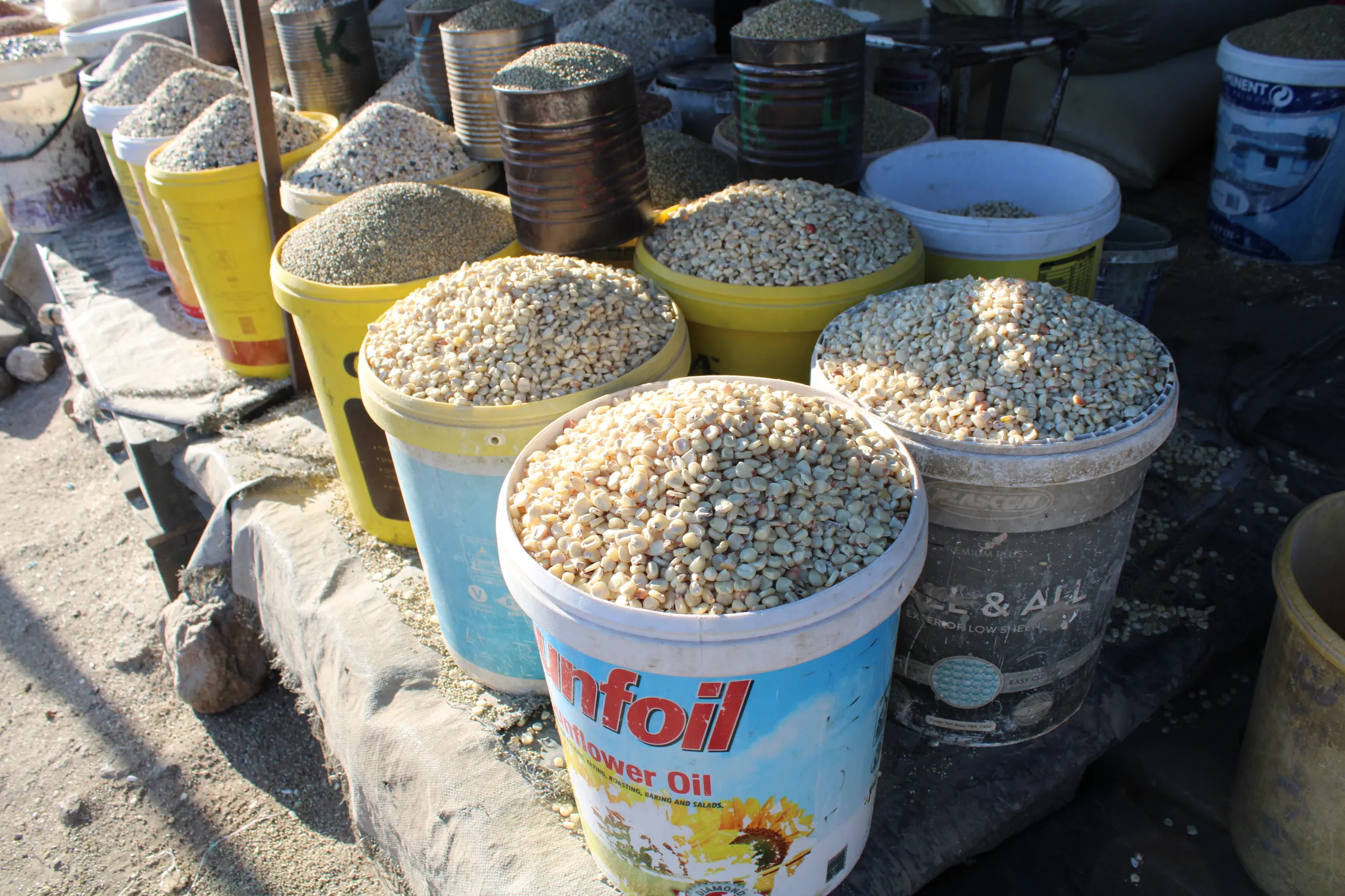 Buckets of maize grains on sale in a street market in Bulawayo, Zimbabwe