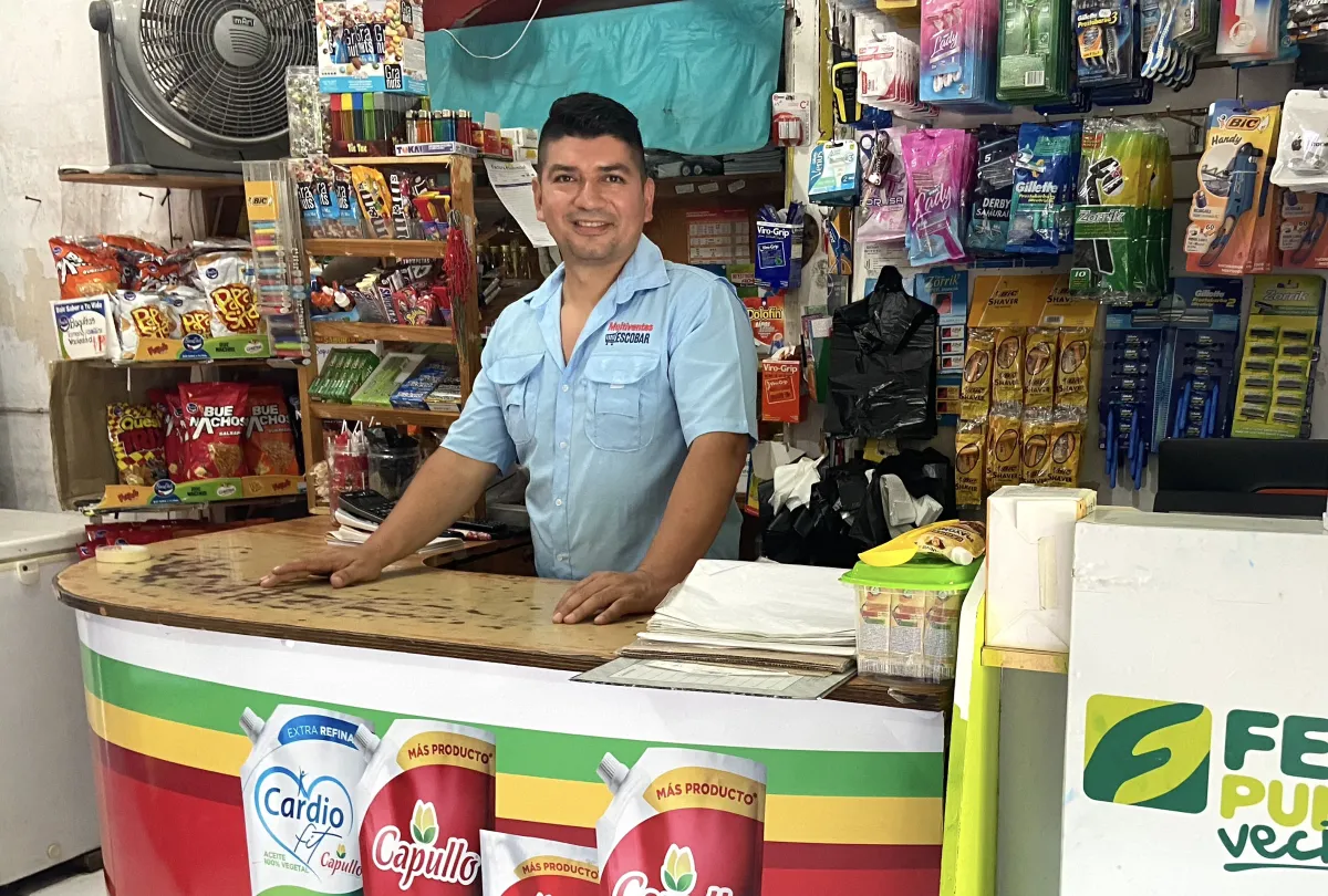 Fredis Escobar stands behind the counter in his shop in Nueva Concepción, El Salvador, on Sept 9, 2022. Thomson Reuters Foundation/Anna-Catherine Brigida