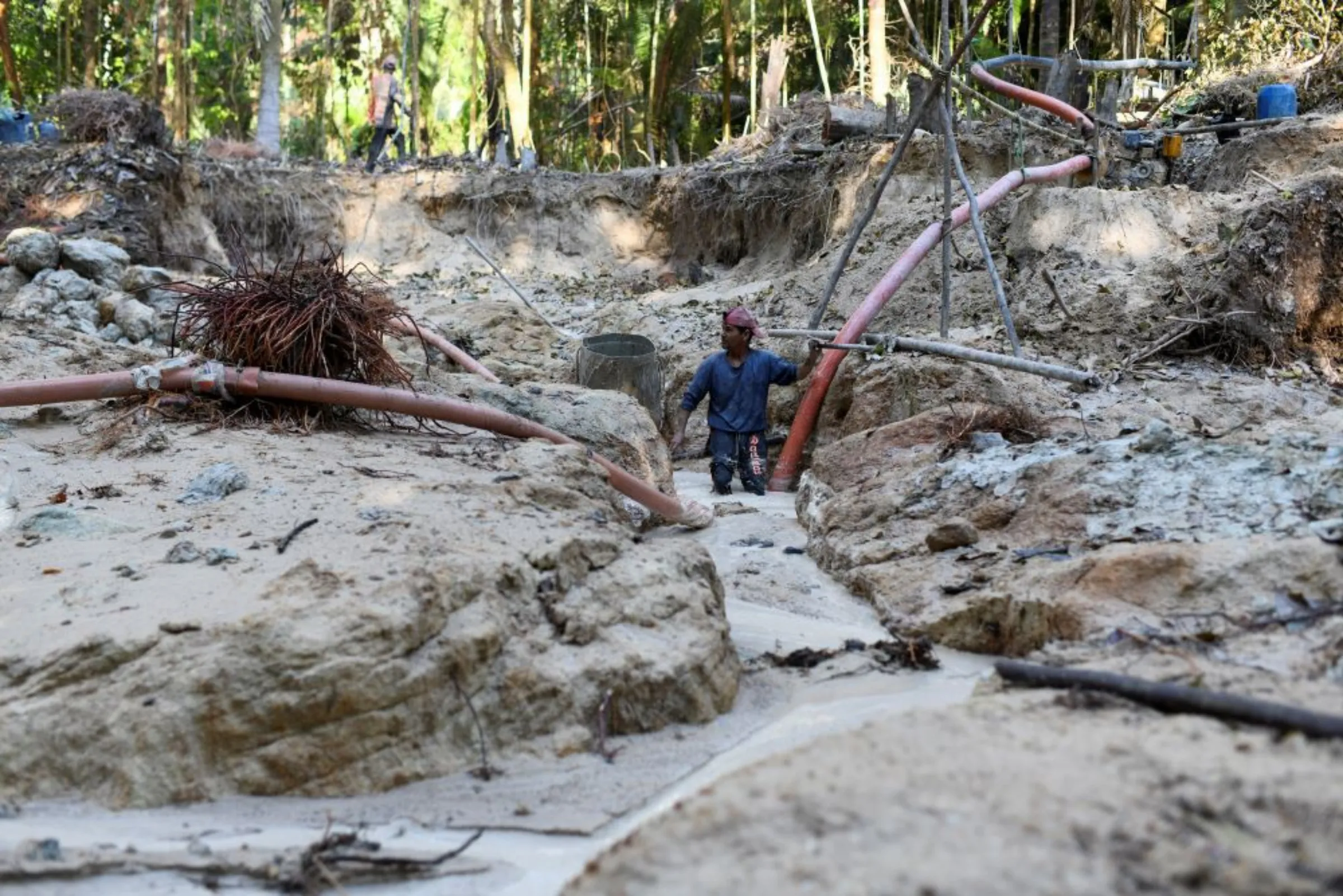 A miner works in an illegal gold mine at an environmental preservation area in the Amazon rainforest, in Itaituba, Para state, Brazil September 3, 2021