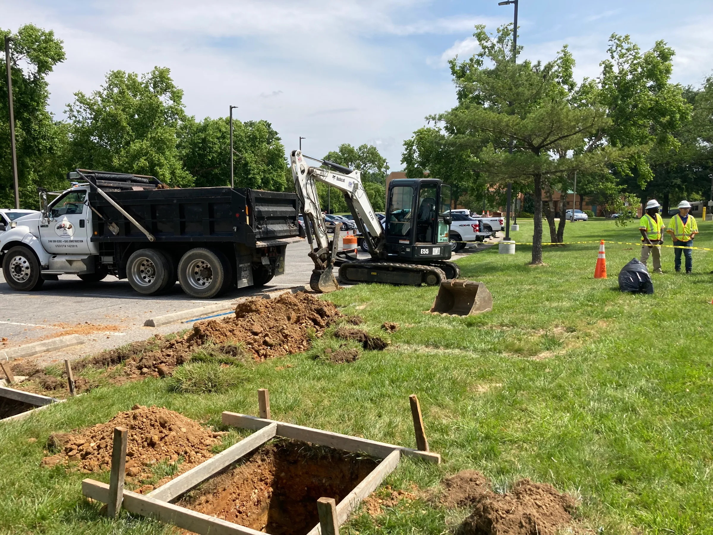 A utility crew begins installation of an electric-vehicle charger at a community center in Temple Hills, Maryland