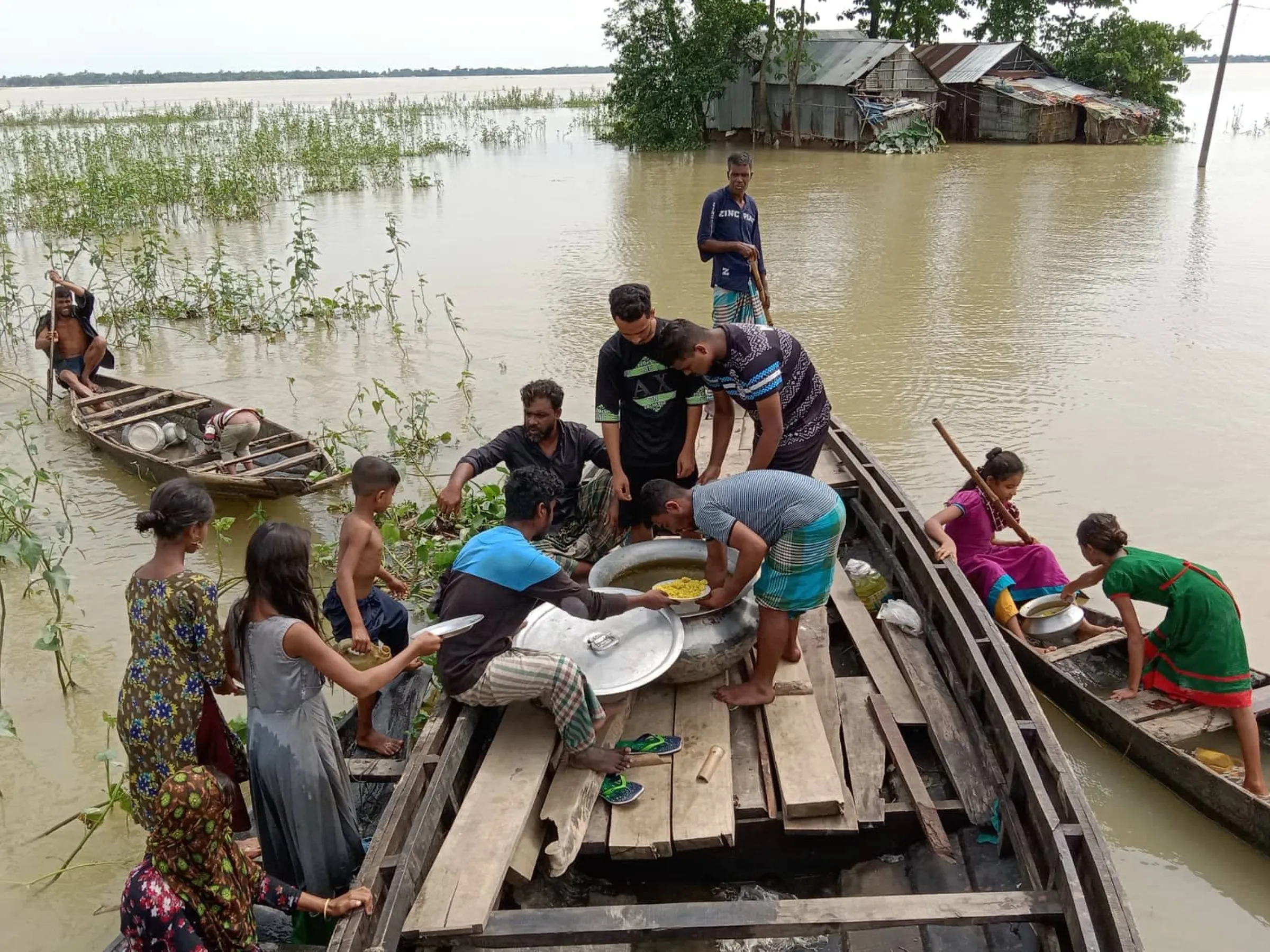 Volunteers distribute relief in the flood-affected Sunamganj region