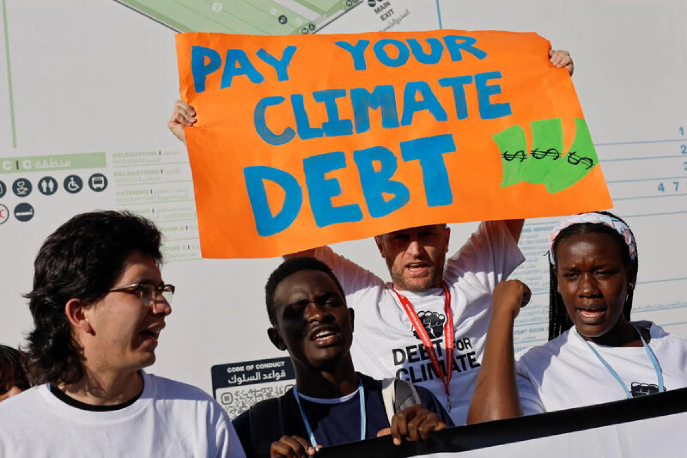 A demonstrator holds a placard as people protest during the COP27 climate summit in Sharm el-Sheikh, Egypt, November 12, 2022. REUTERS/Mohammed Salem