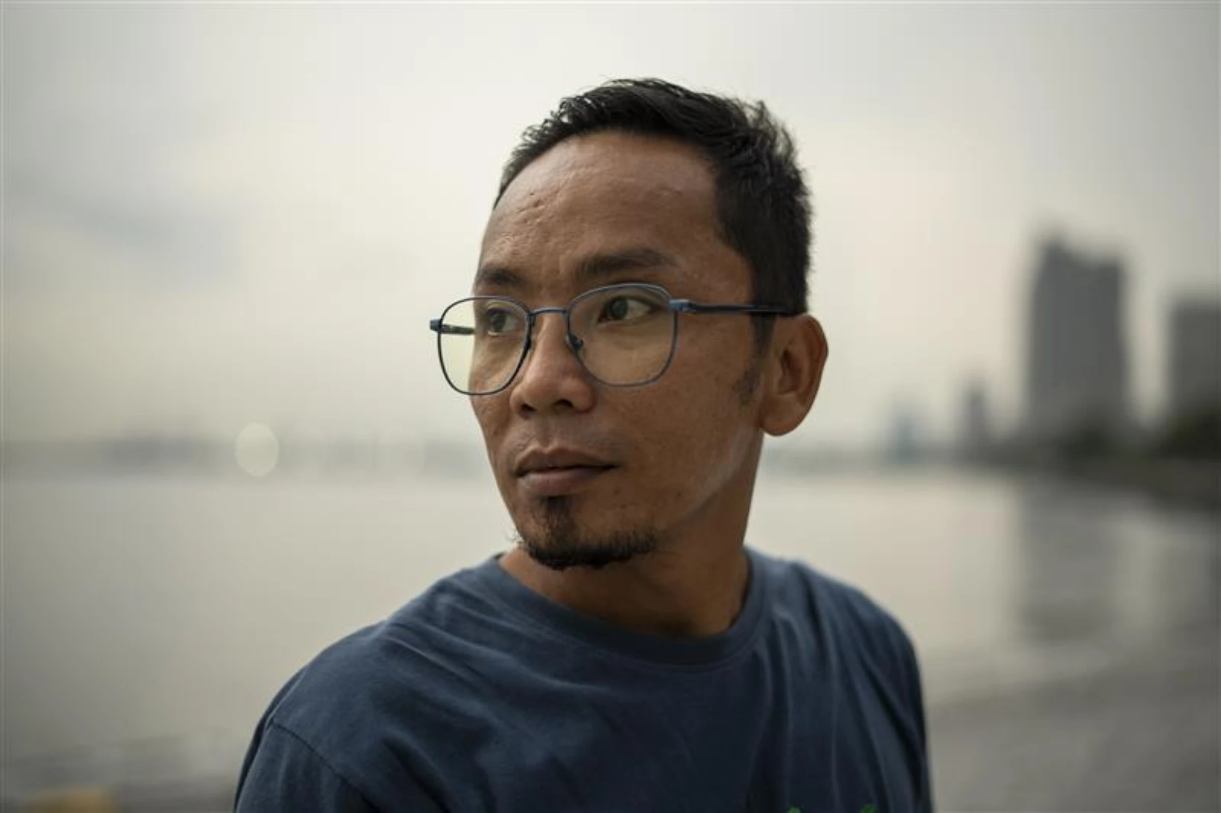 Filipino fisherman Nante Maglangit poses for a photo after an interview, along Manila Bay in Manila, Philippines, May 6, 2025. Thomson Reuters Foundation/Lisa Marie David