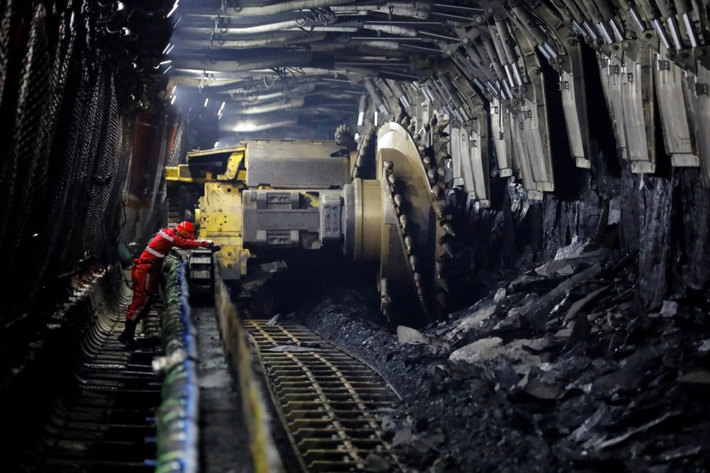 A media reporter uses his camera at an underground coalface where Huawei 5G base stations are deployed to support communication and remote control, at Xiaobaodang Coal Mine in Shenmu of Yulin city, Shaanxi province, China, April 26, 2023. REUTERS/Tingshu Wang