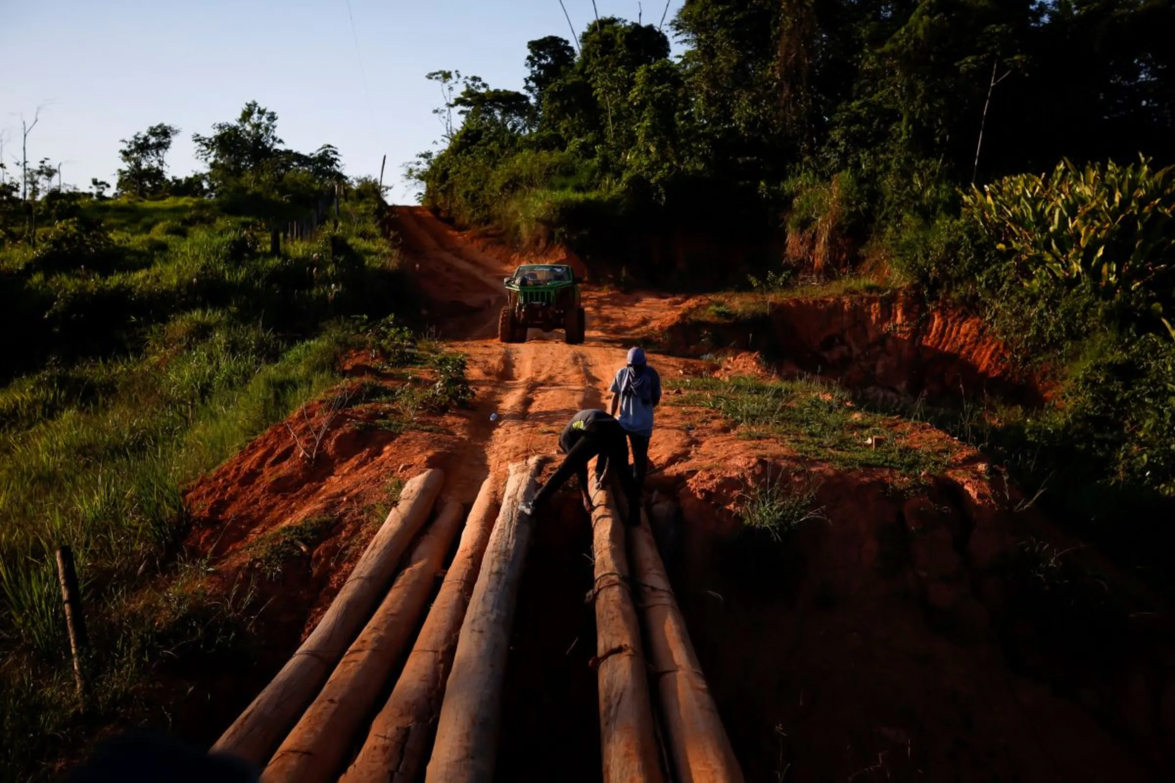 Drivers fix a wooden bridge on a dirt road, where illegal miners are arriving after leaving the Yanomami indigenous land, in Alto Alegre, Roraima state, Brazil, February 7, 2023