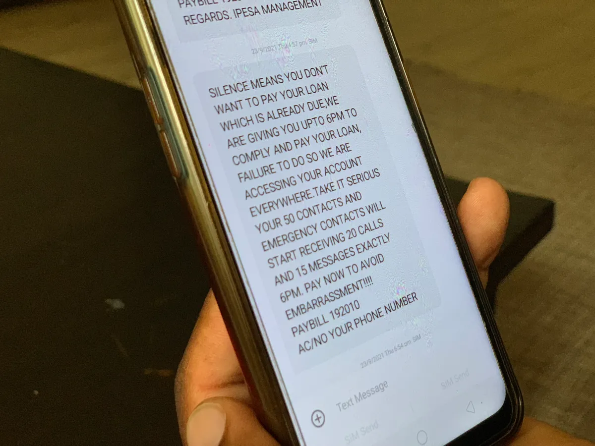 A man shows a text message sent by digital lender Ipesa to his phone in Nairobi, Kenya on Nov. 29, 2021. Thomson Reuters Foundation/Nita Bhalla