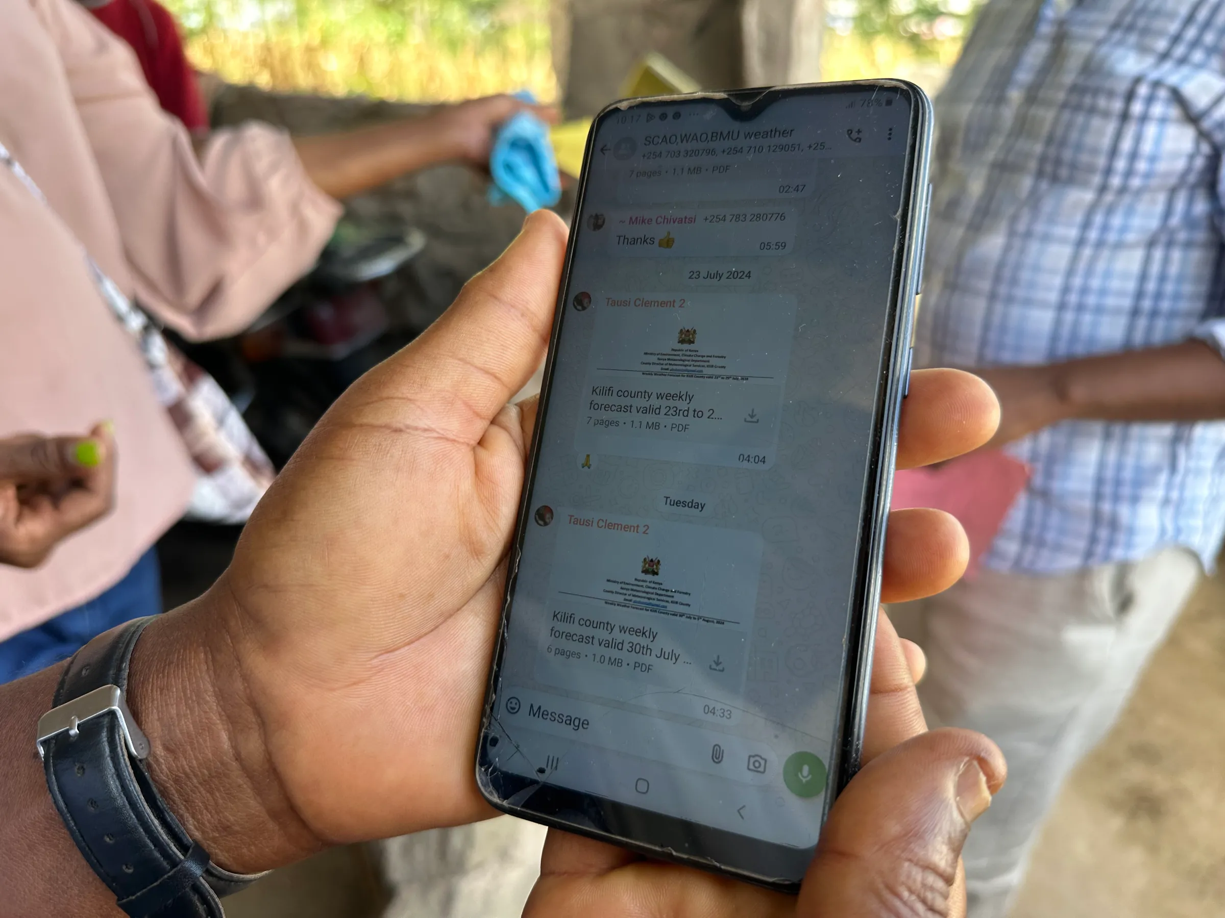 A WhatsApp group on farmer Teresa Kahindi's phone, where she receives weather warnings and farming advice, August 5, 2024. Thomson Reuters Foundation/Peter Yeung