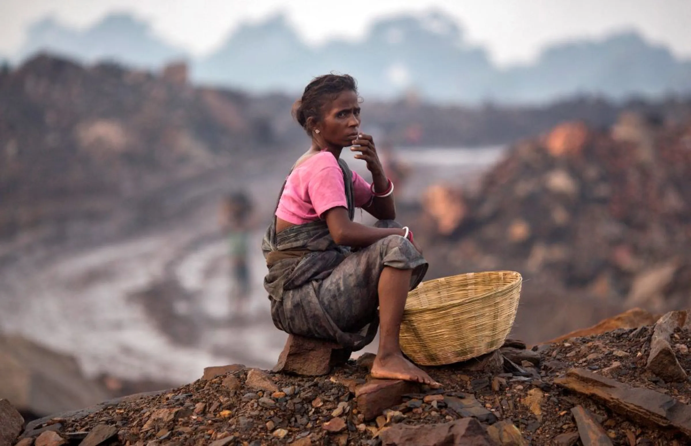 A local woman sits atop of an open cast coal field at Dhanbad district in the eastern Indian state of Jharkhand September 20, 2012